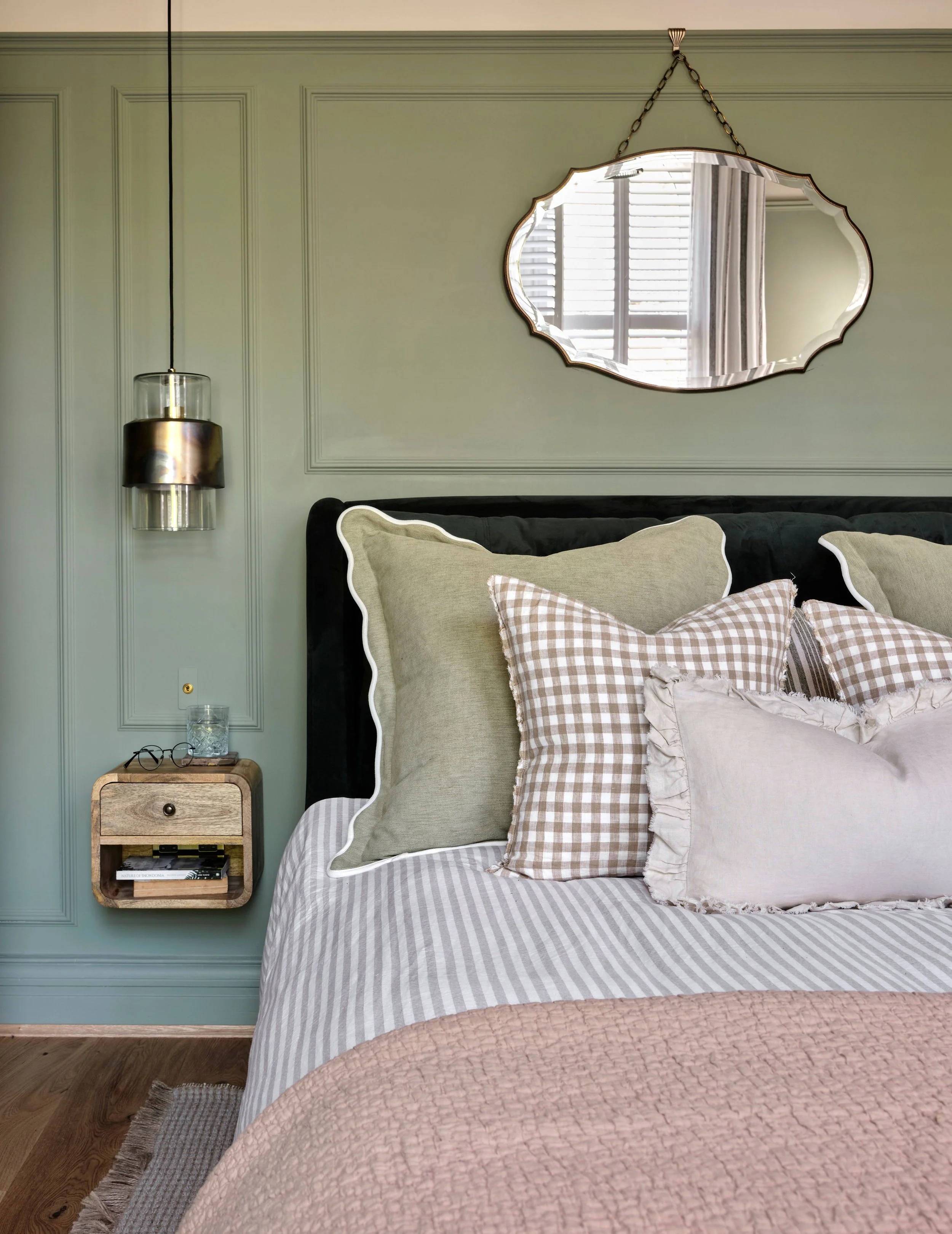 Wainscoting panelling used to mirror the dimensions of the bed and bedside tables adding to the bespoke details in the carefully curated space