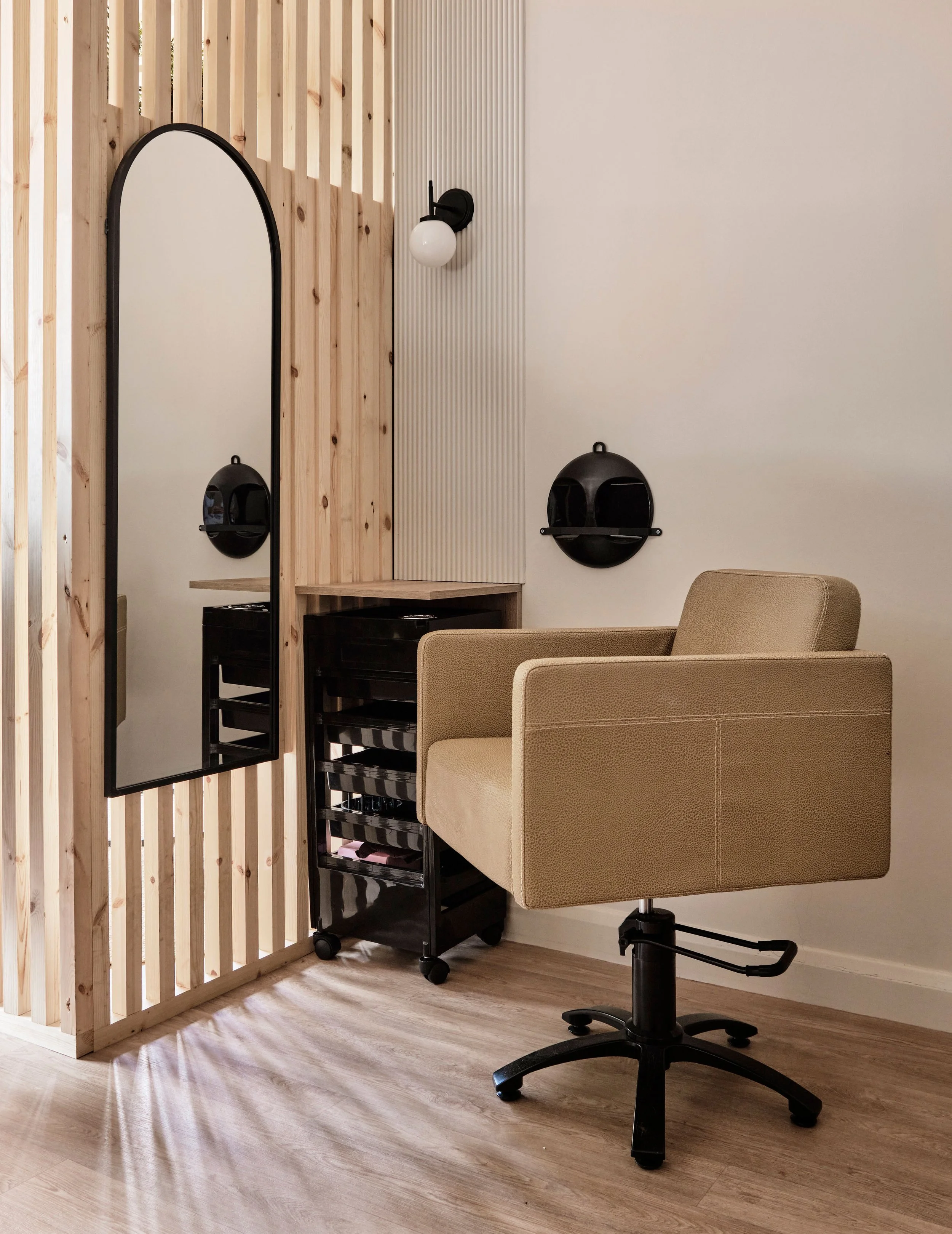 Wooden slatted dividers create privacy without compromising on space in this bright and spacious salon redesign