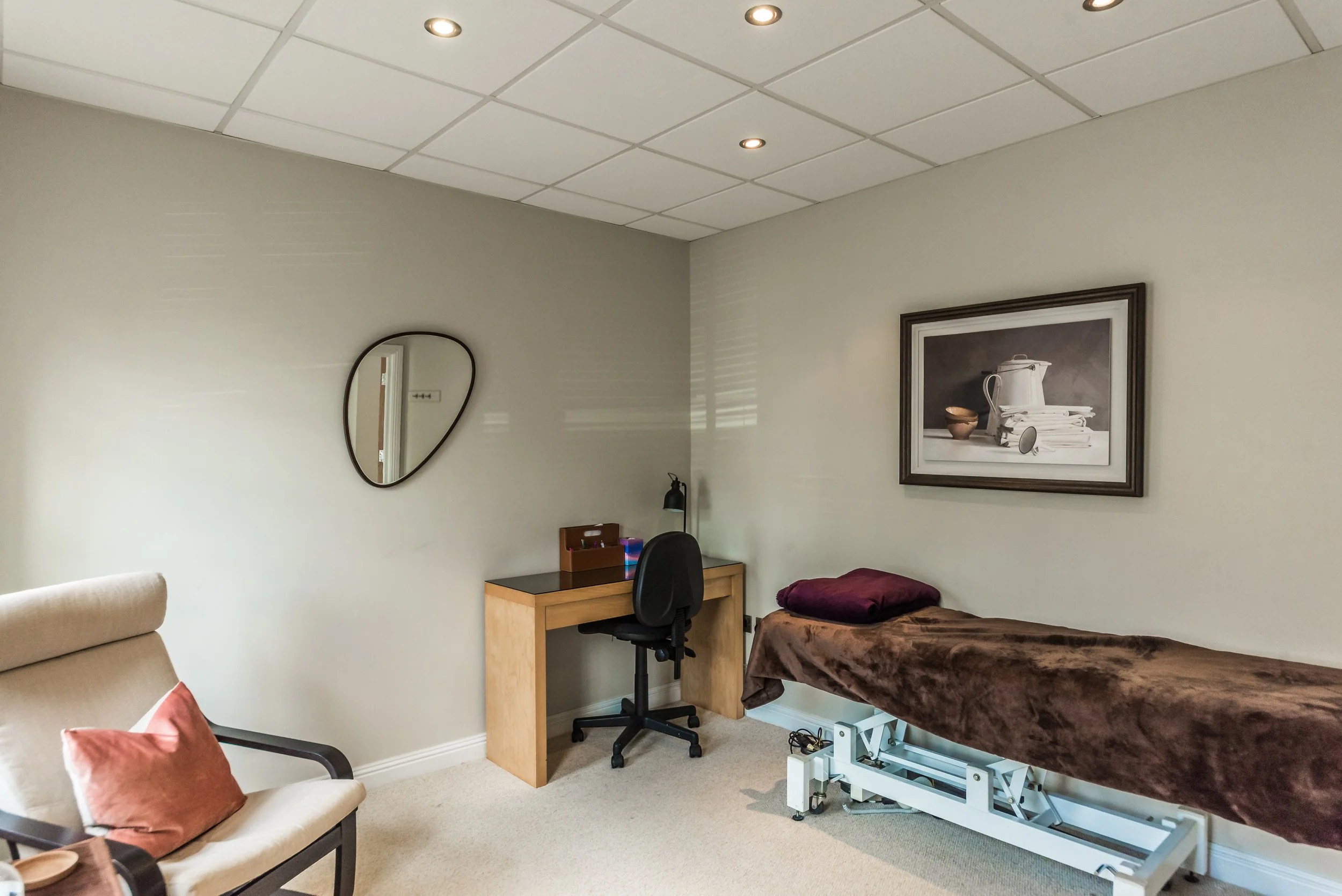 Therapy Room set up for Reflexology session with electric couch and swivel chair