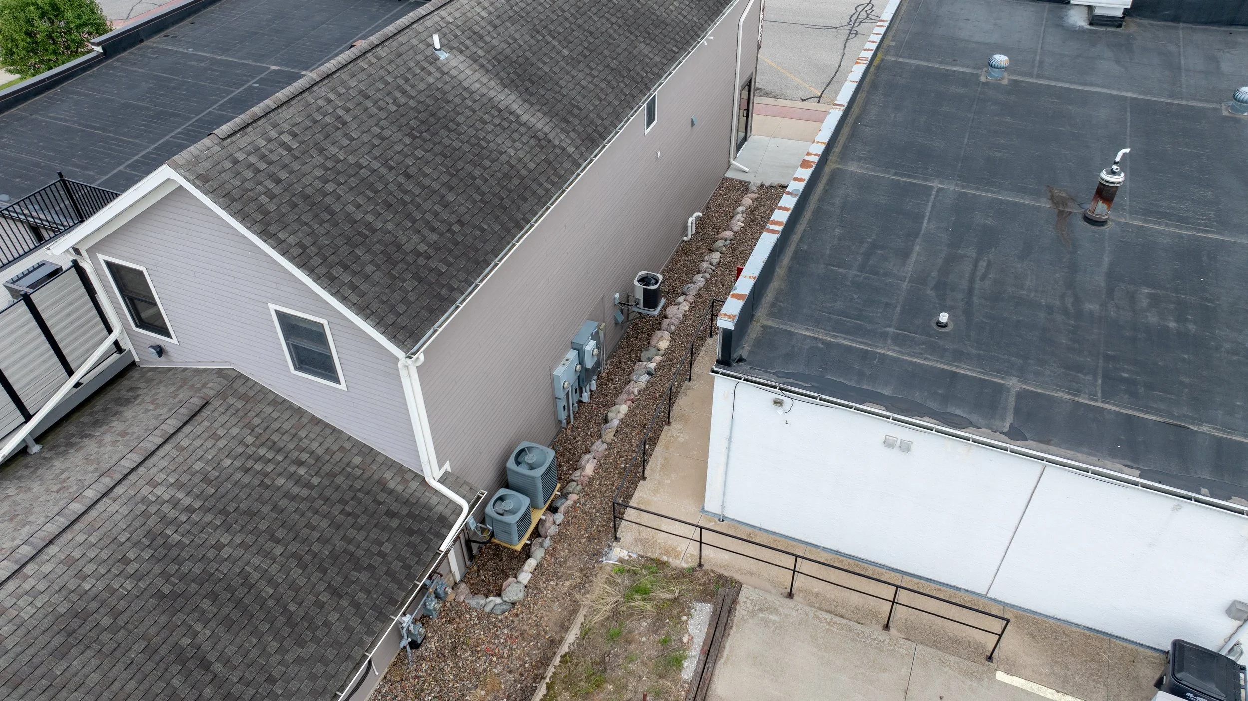 Aerial view of boulder-lined landscape bed between buildings.