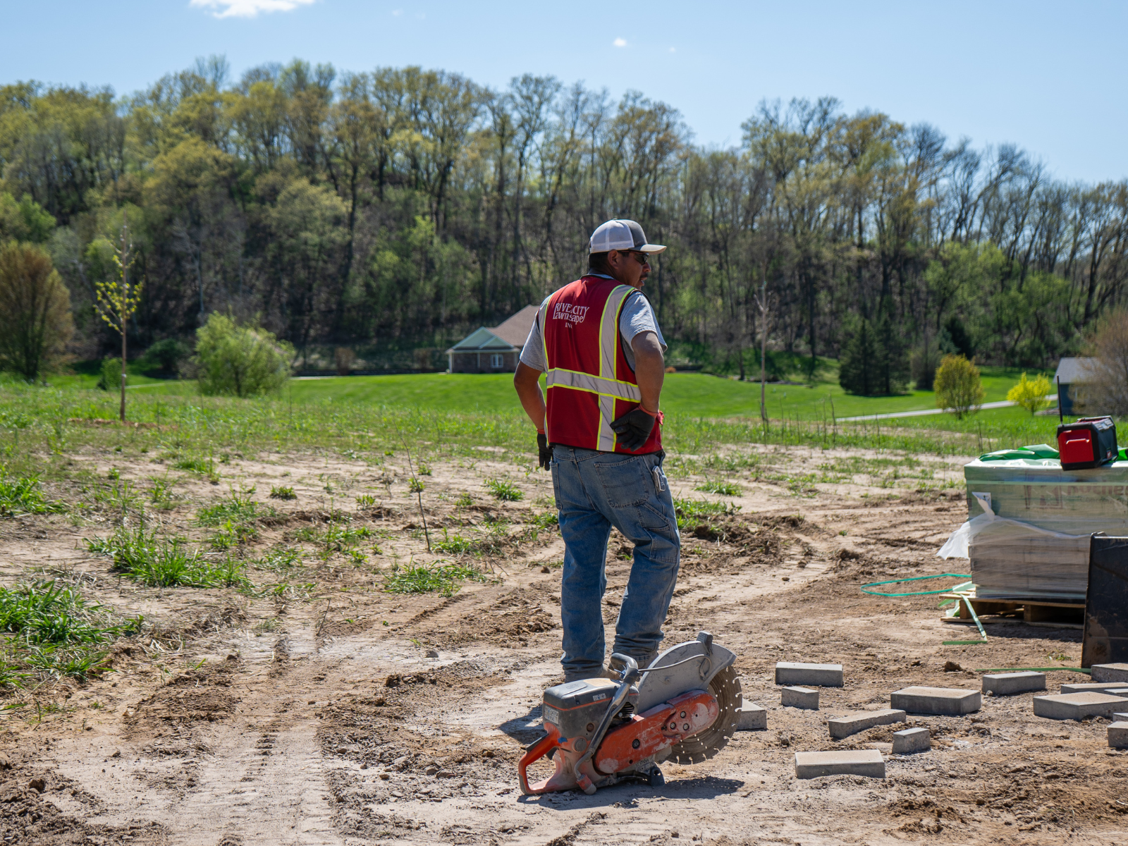  Crew grading and preparing lawn area during landscape installation 