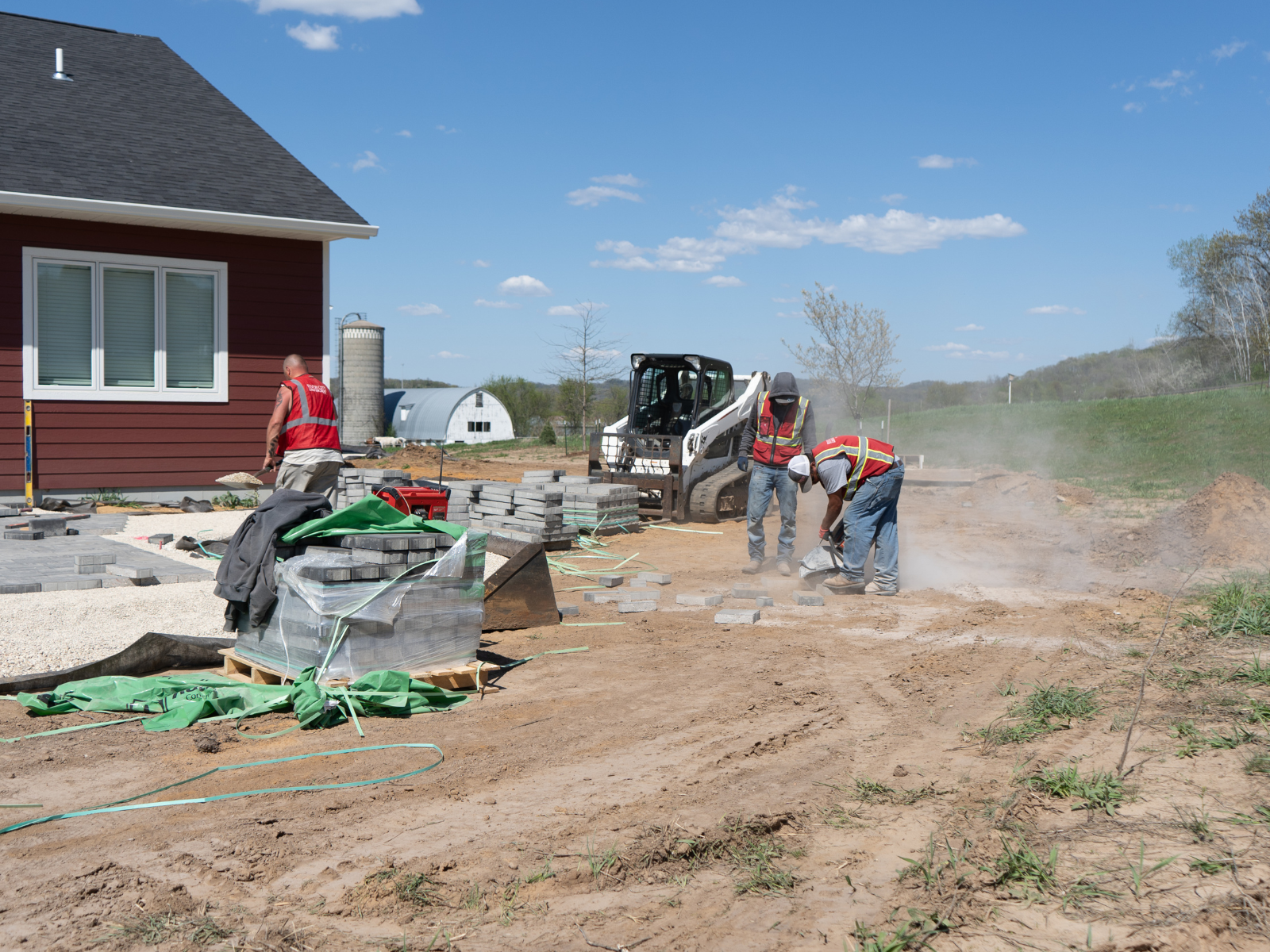  Landscape installation with equipment preparing base for patio construction 