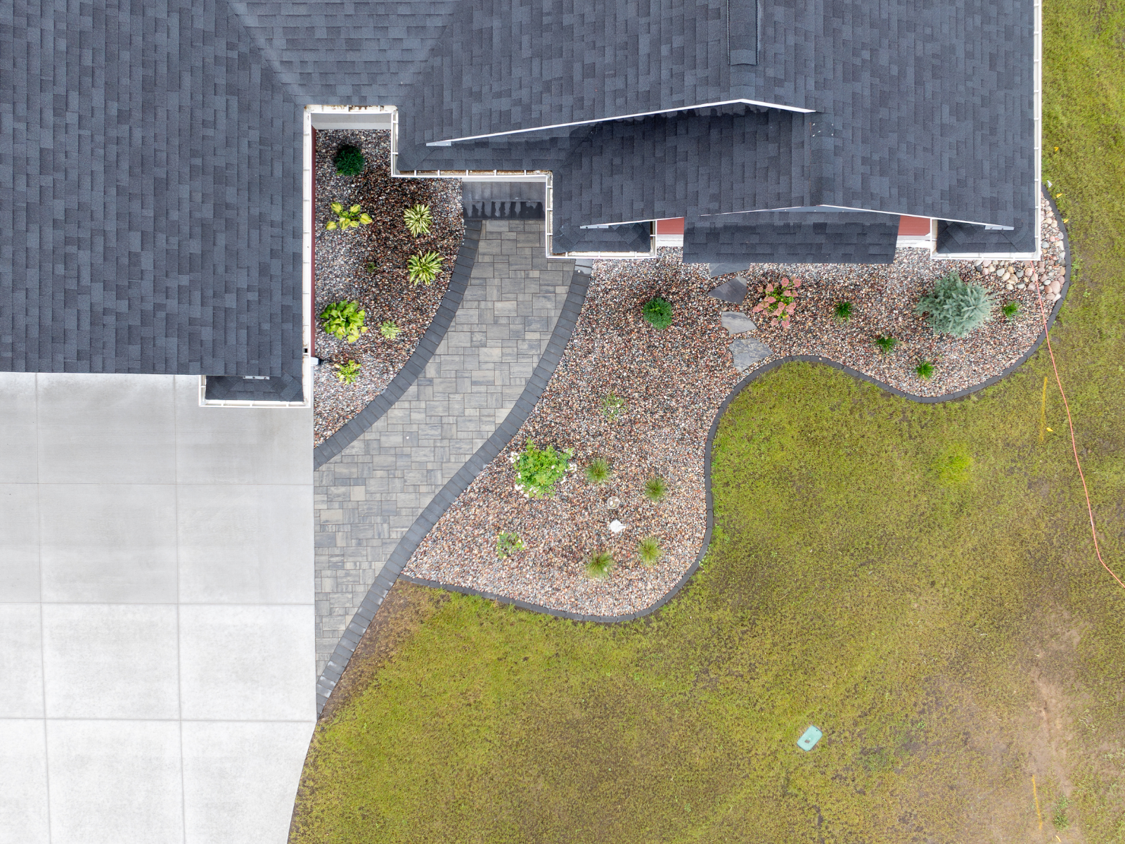  Aerial view of curved patio and walkway layout integrated with lawn and planting beds 