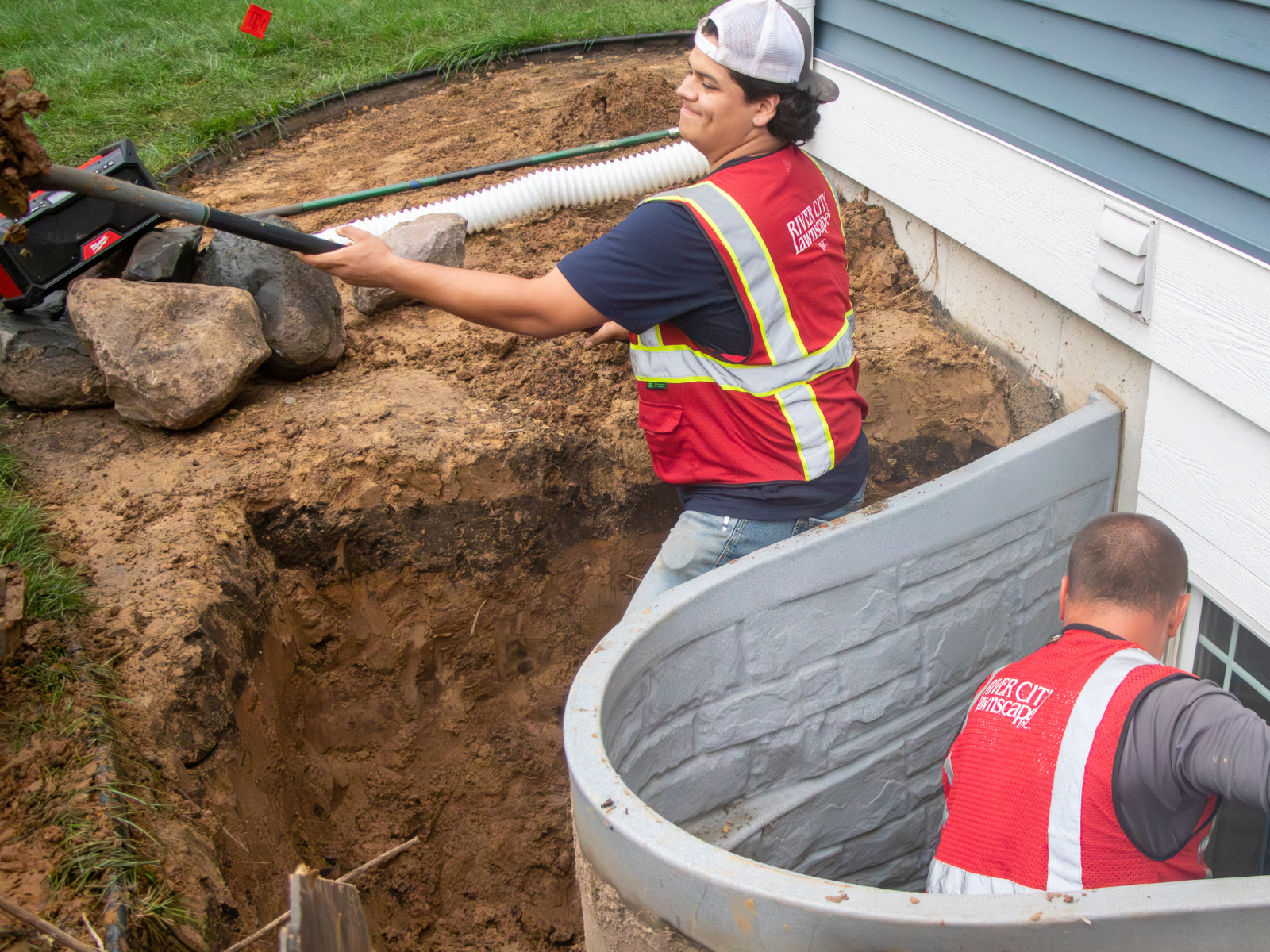  Crew installing curved window well during excavation 