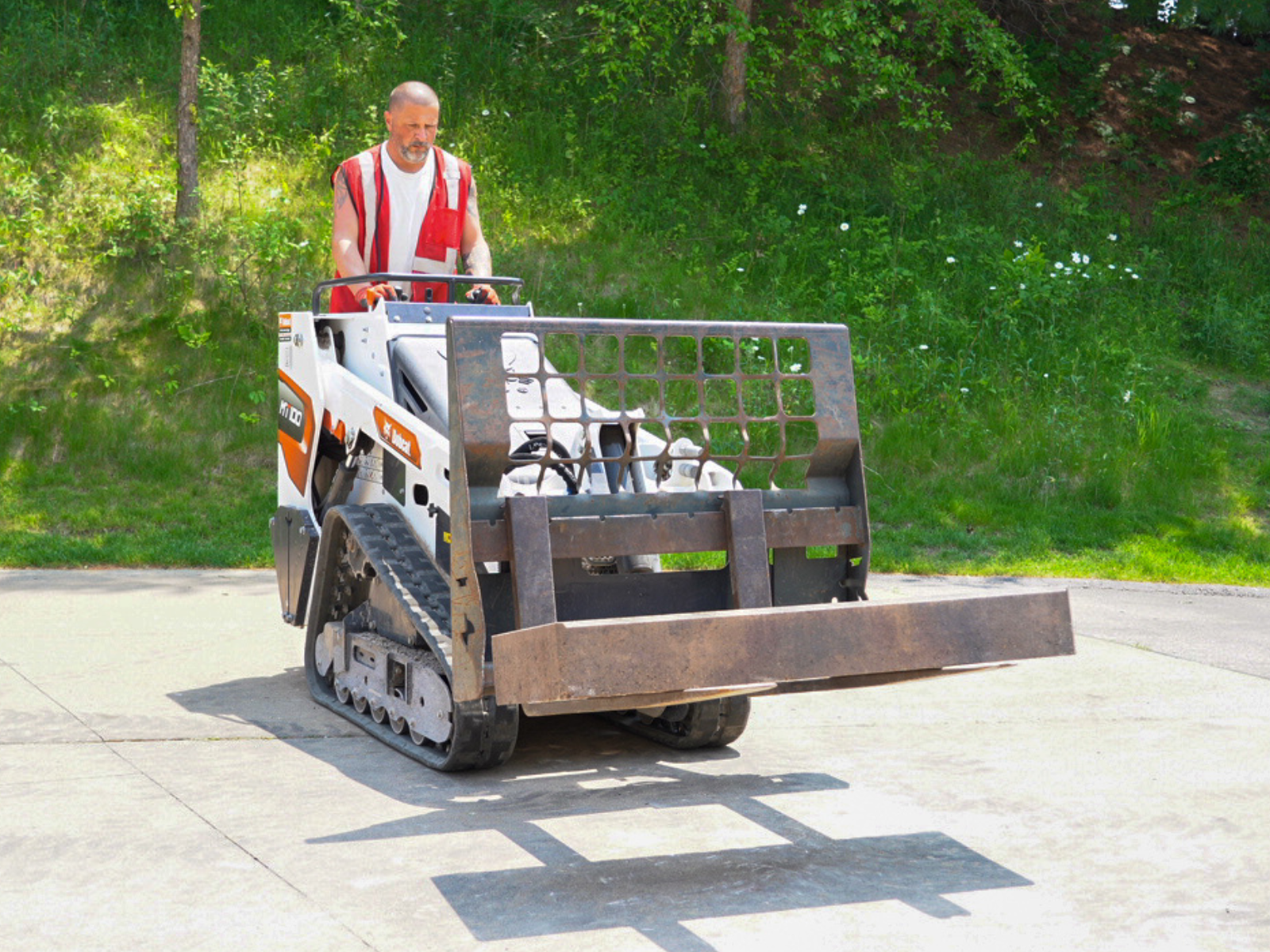 Compact equipment transporting materials during landscape installation.
