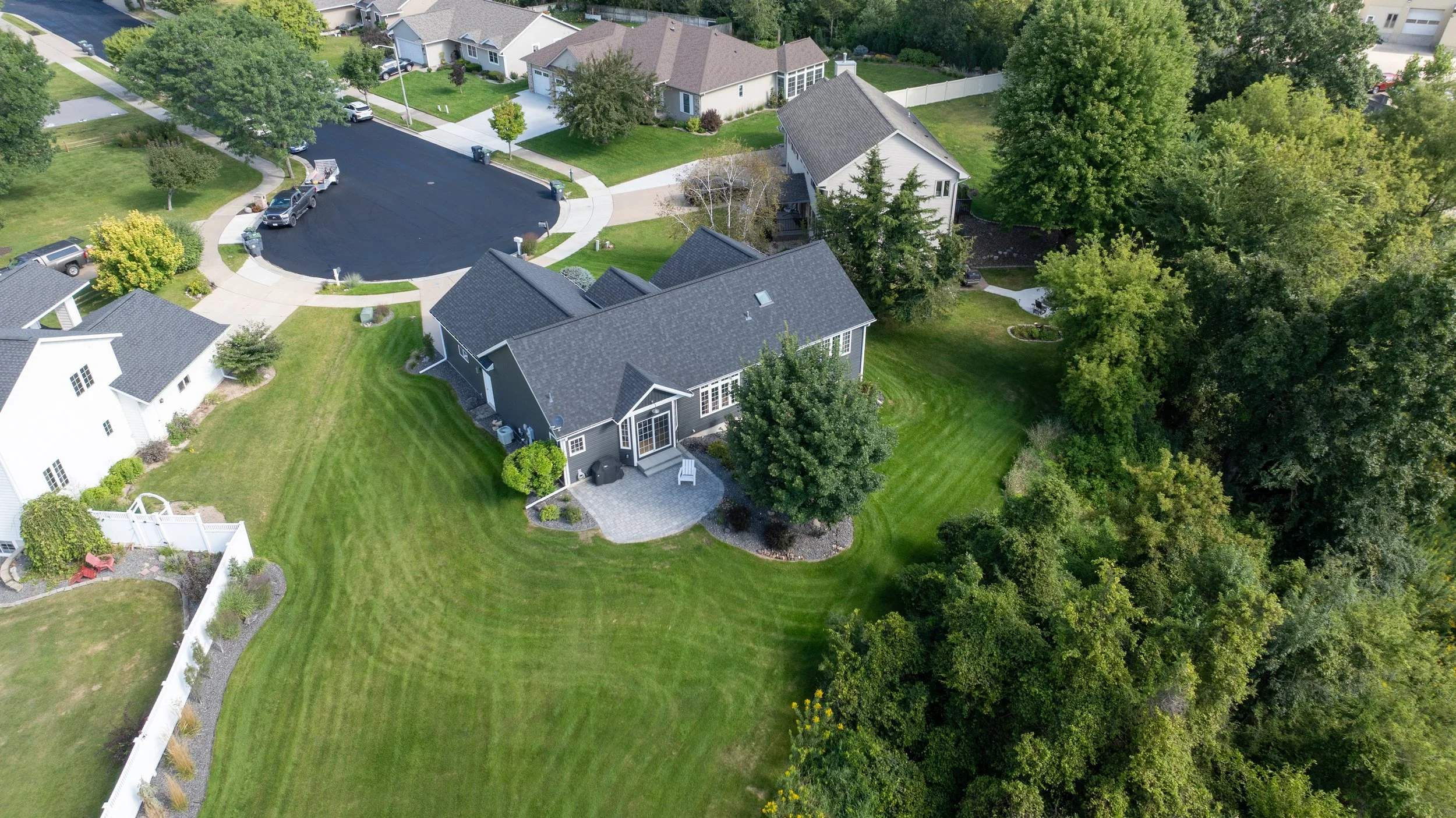 Angled aerial view of completed patio and landscaped backyard.