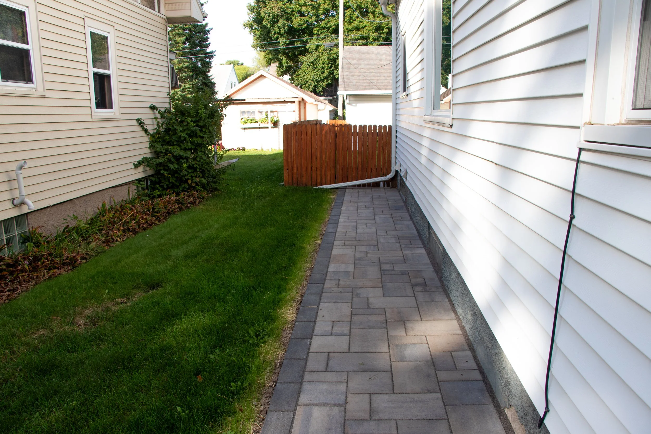 Side of house yard and stone walkway