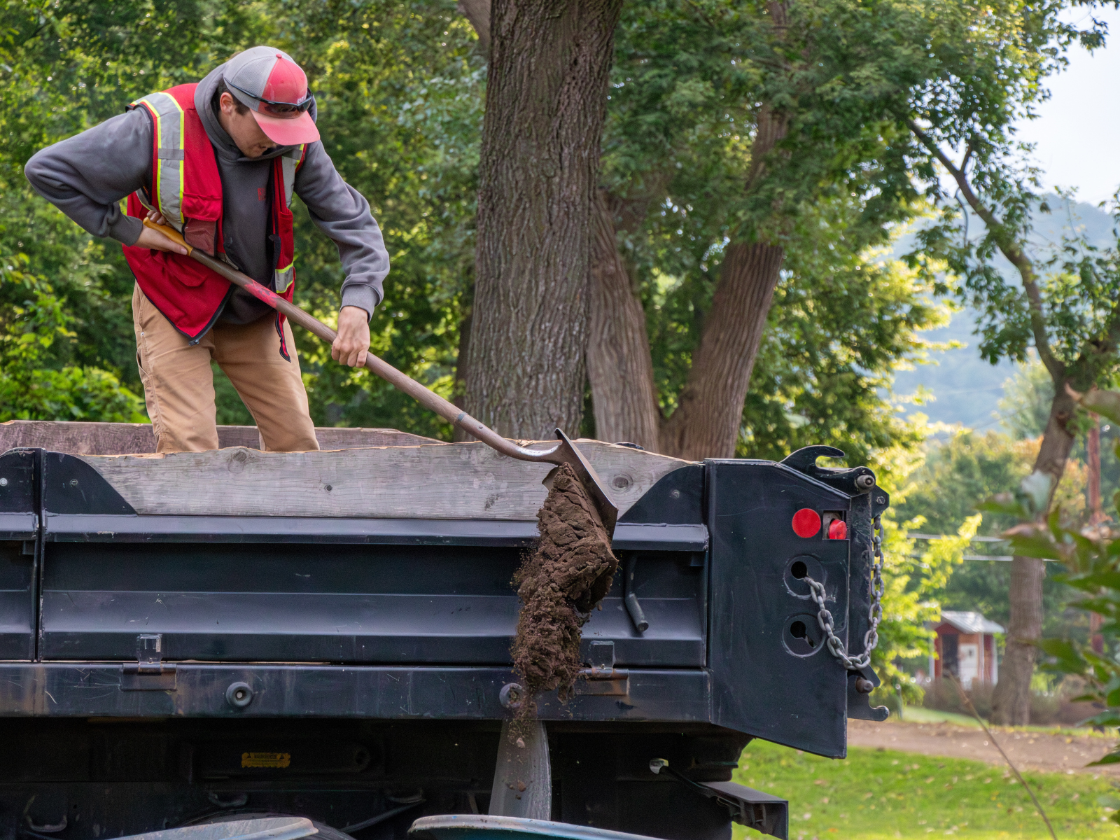 RCL employee scooping dirt