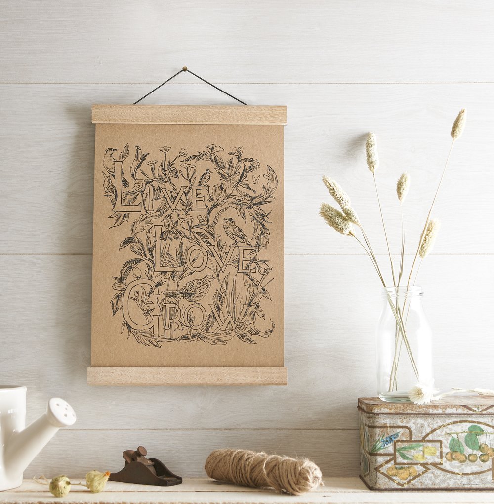  Small framed manilla poster hung on wall with illustration upon photographed in rustic setting created in the studio 