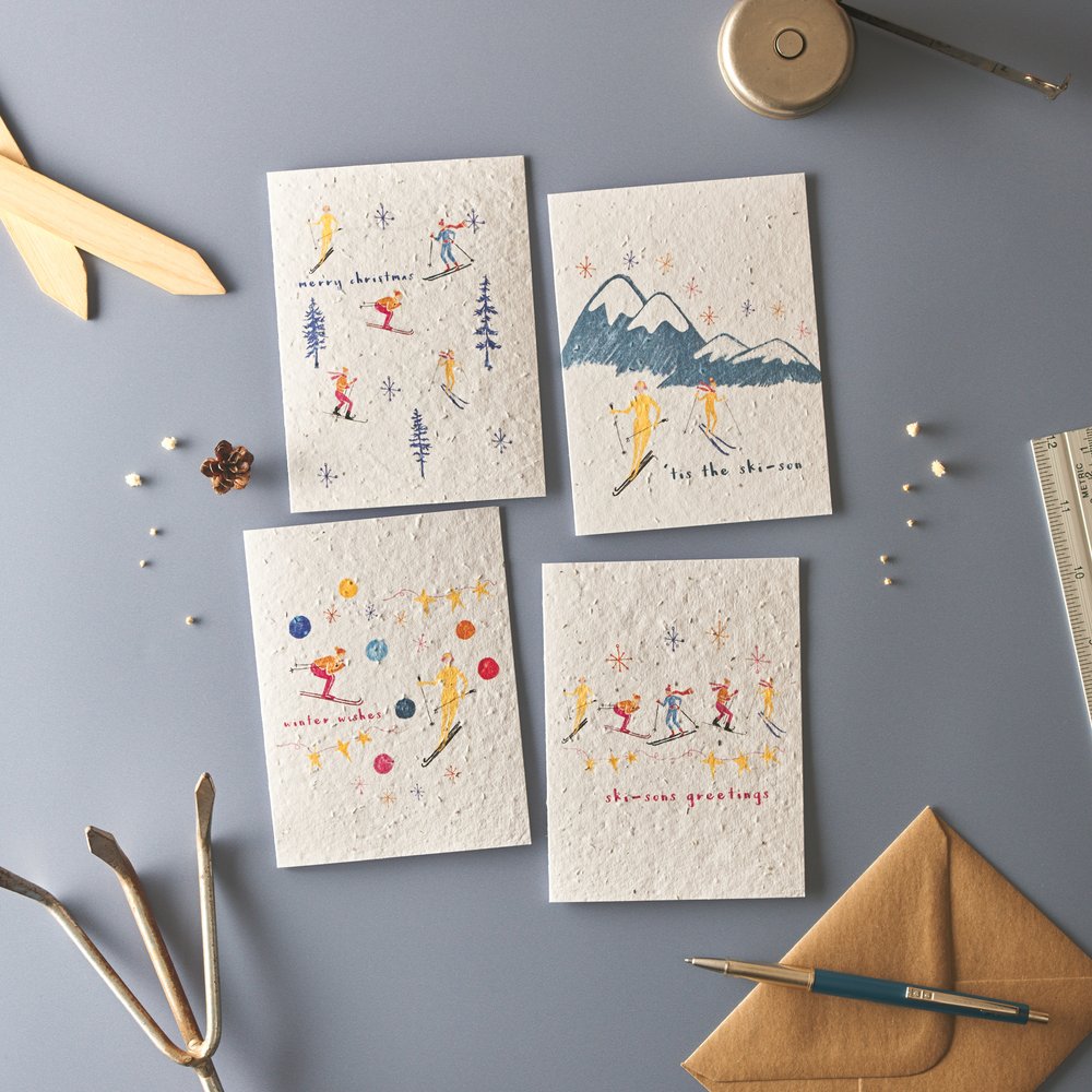  Overhead photograph of four greeting cards in nordic theme with props 