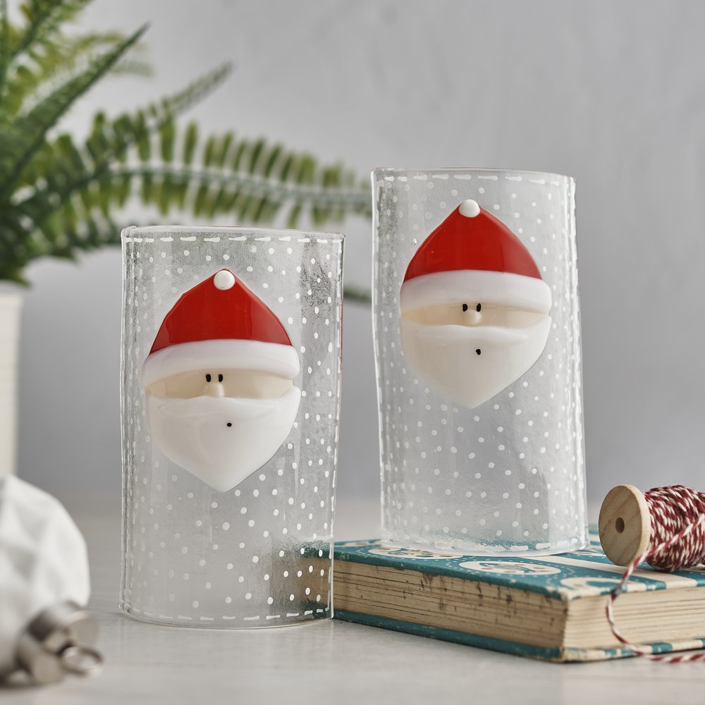  Handmade Christmas themed glass curves standing on vintage book and plant in background 