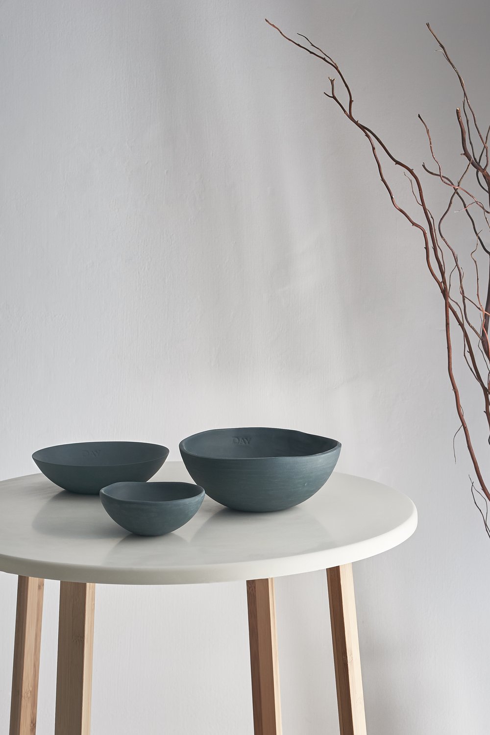 Group of three ceramicist bowls photographed in contemporary setting 