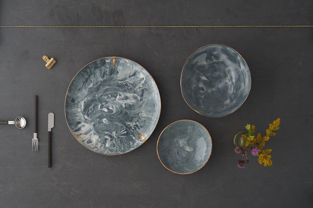  Overhead image of handmade decorative plates styled with wild flowers and modernist props 
