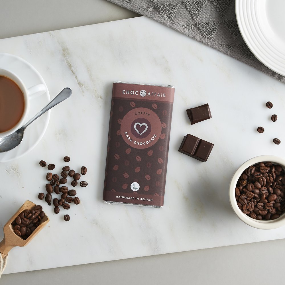  Coffee flavour chocolate bar with shards of chocolate and coffee beans and cup 