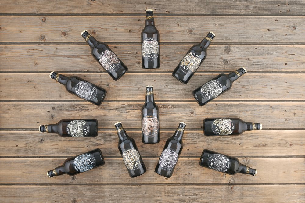  Geometric formation of beer bottles photographed on rustic planked surface, beers from brewery Wold Top 