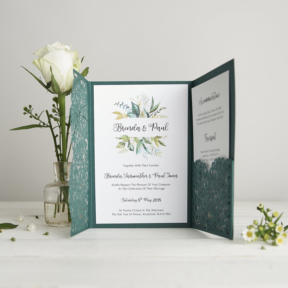  Wedding stationery invitations and detail card photographed next to fresh flower in small glass vase 2 