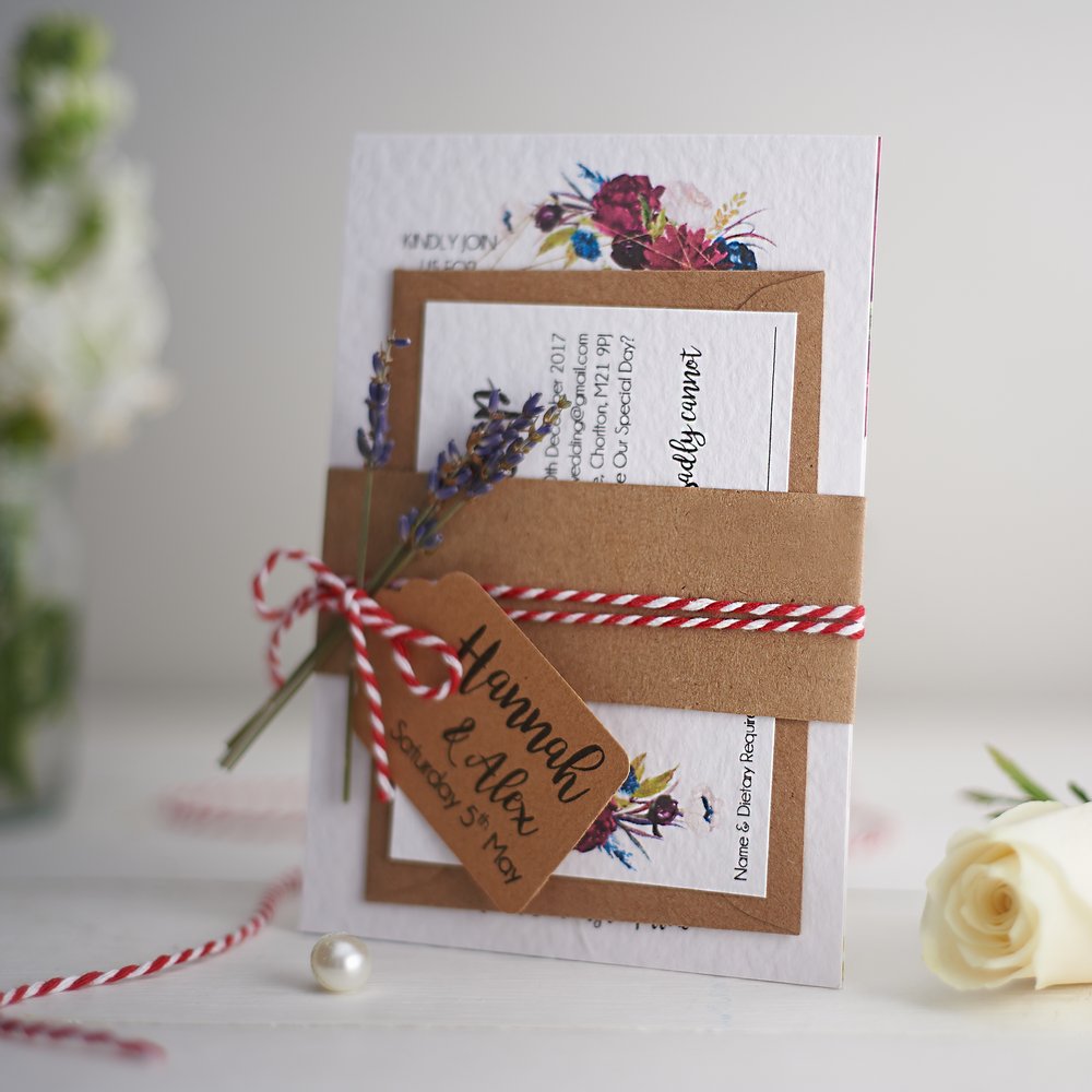  Wedding stationery photographed next to fresh flower in small glass vase out of focus in background 3 
