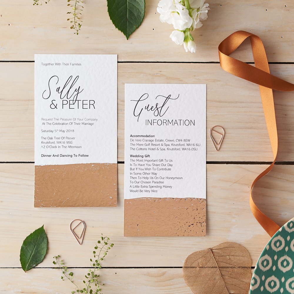  Wedding stationery invitations and detail card photographed on pale wooden background with props 