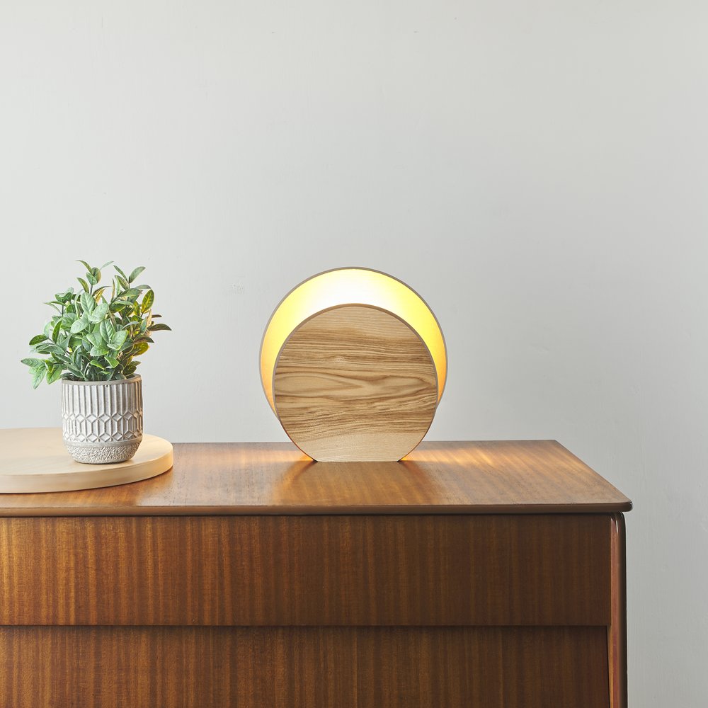  Chest of drawers with circular contemporary lamp upon 