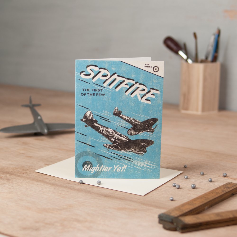  Spitfire illustrated greeting card photographed with silver cake balls as bullets 