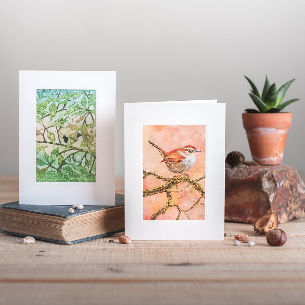  Nature focussed illustrative greeting cards photographed in rustic style with rustic brick, vintage book and conkers 