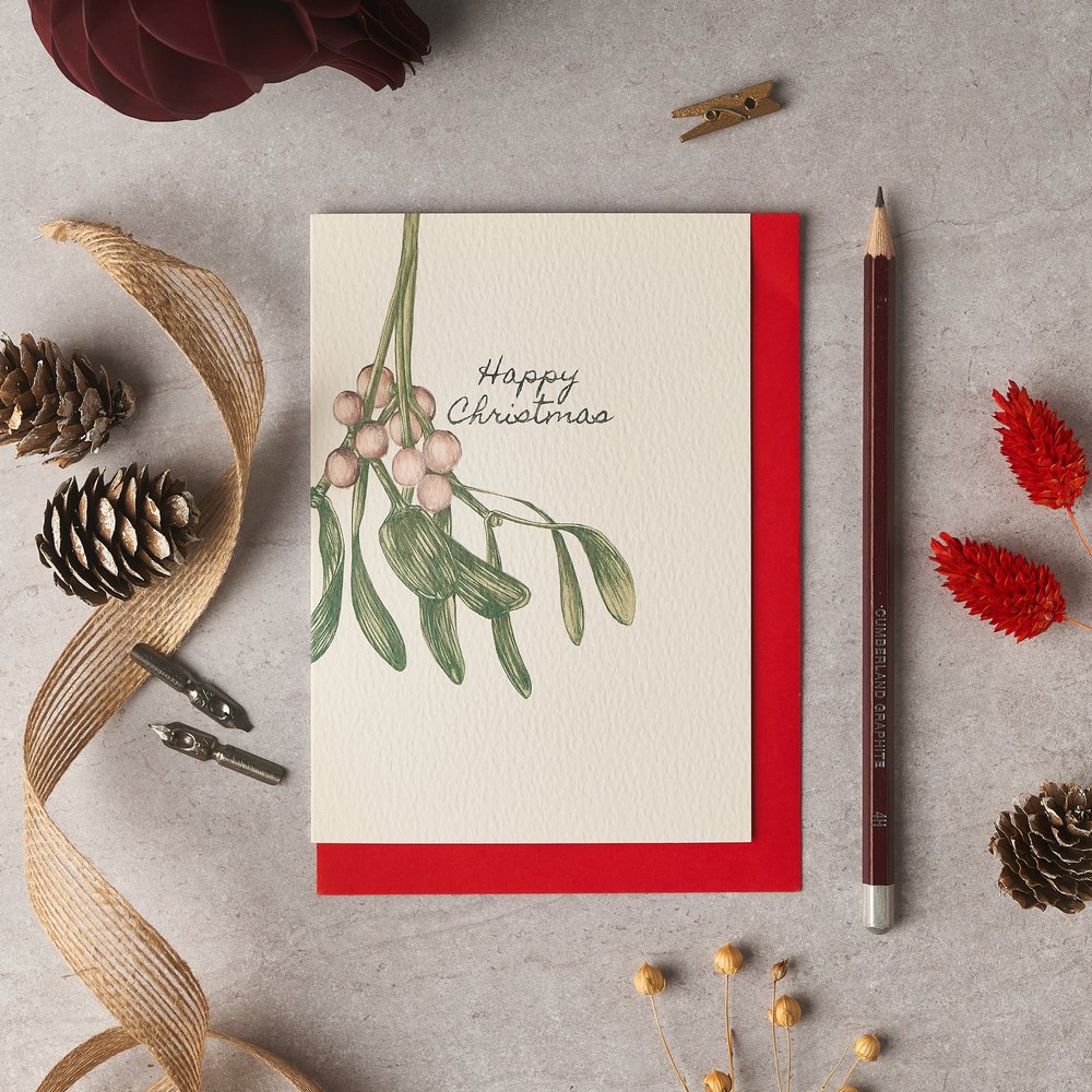  Christmas themed greeting card product photograph with various festive props around the card 