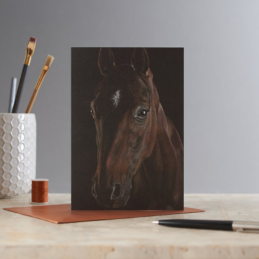  Equine themed dark greeting card with illustration of horse to front photographed in simple studio setting on marble  