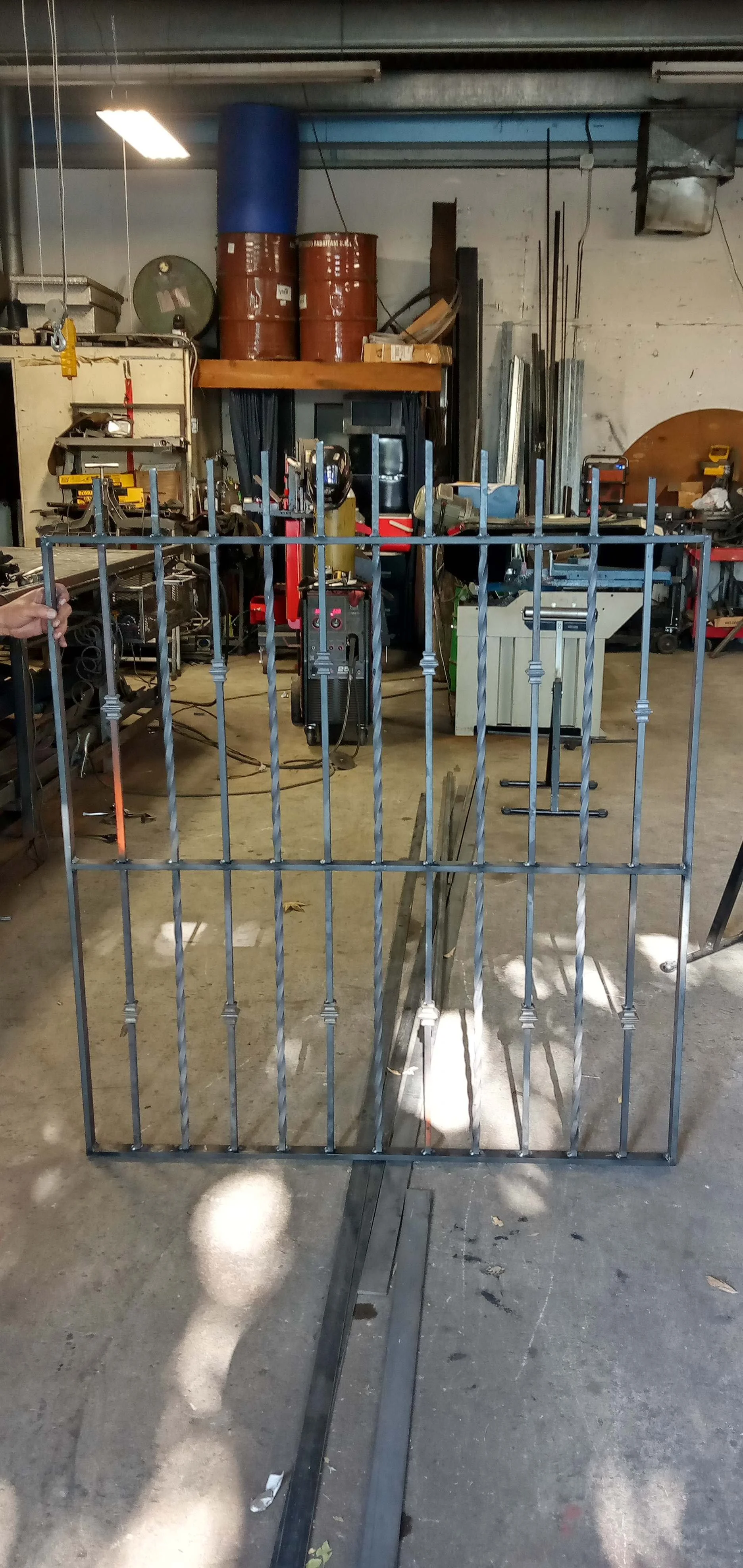 The power of precision in our warehouse gallery, where our expert welds iron for crucial projects in the area.