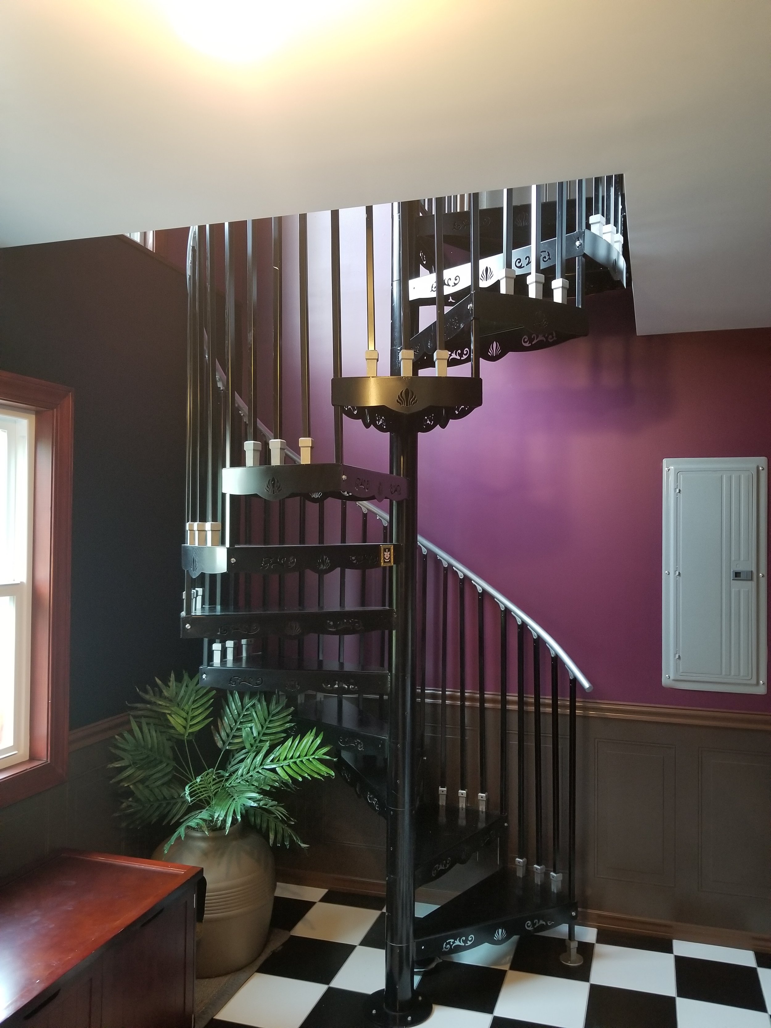 A stylish home interior where a staircase adorned with black handrails takes center stage.