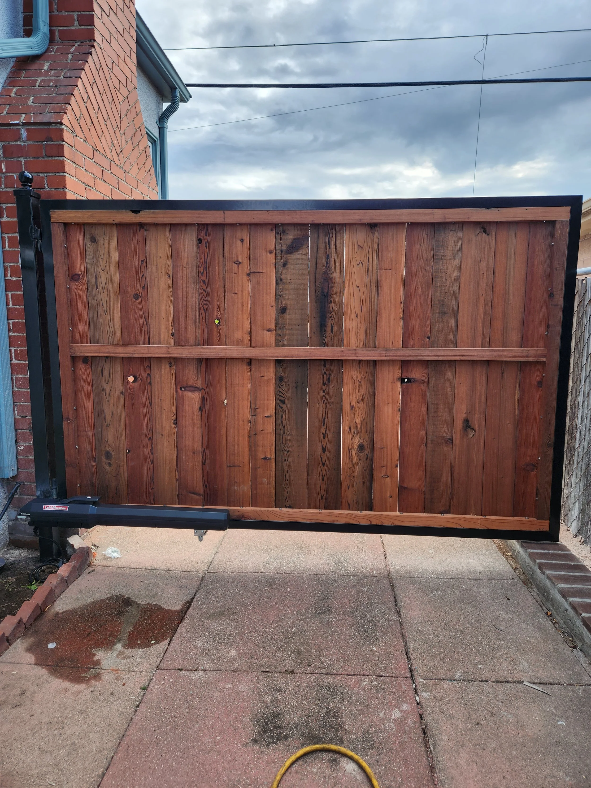 The garage of a house design of a wooden door and black iron project, the welding was performed by the best expert in this type of project