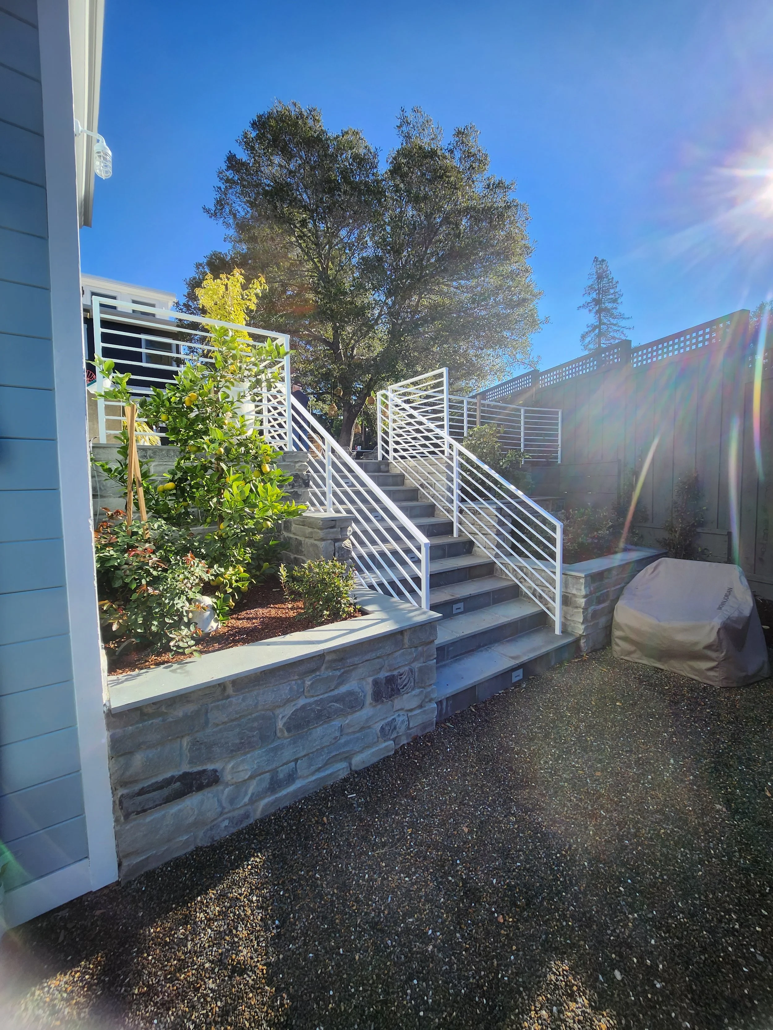 Showcasing a house garden adorned with pristine white handrails, gracefully guiding the way to the second floor. 
