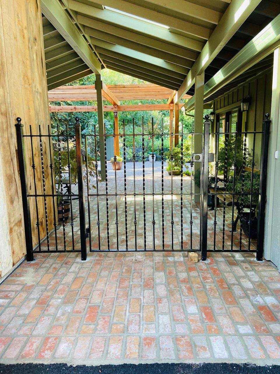 The house has a black iron gate to separate the section of the house. 