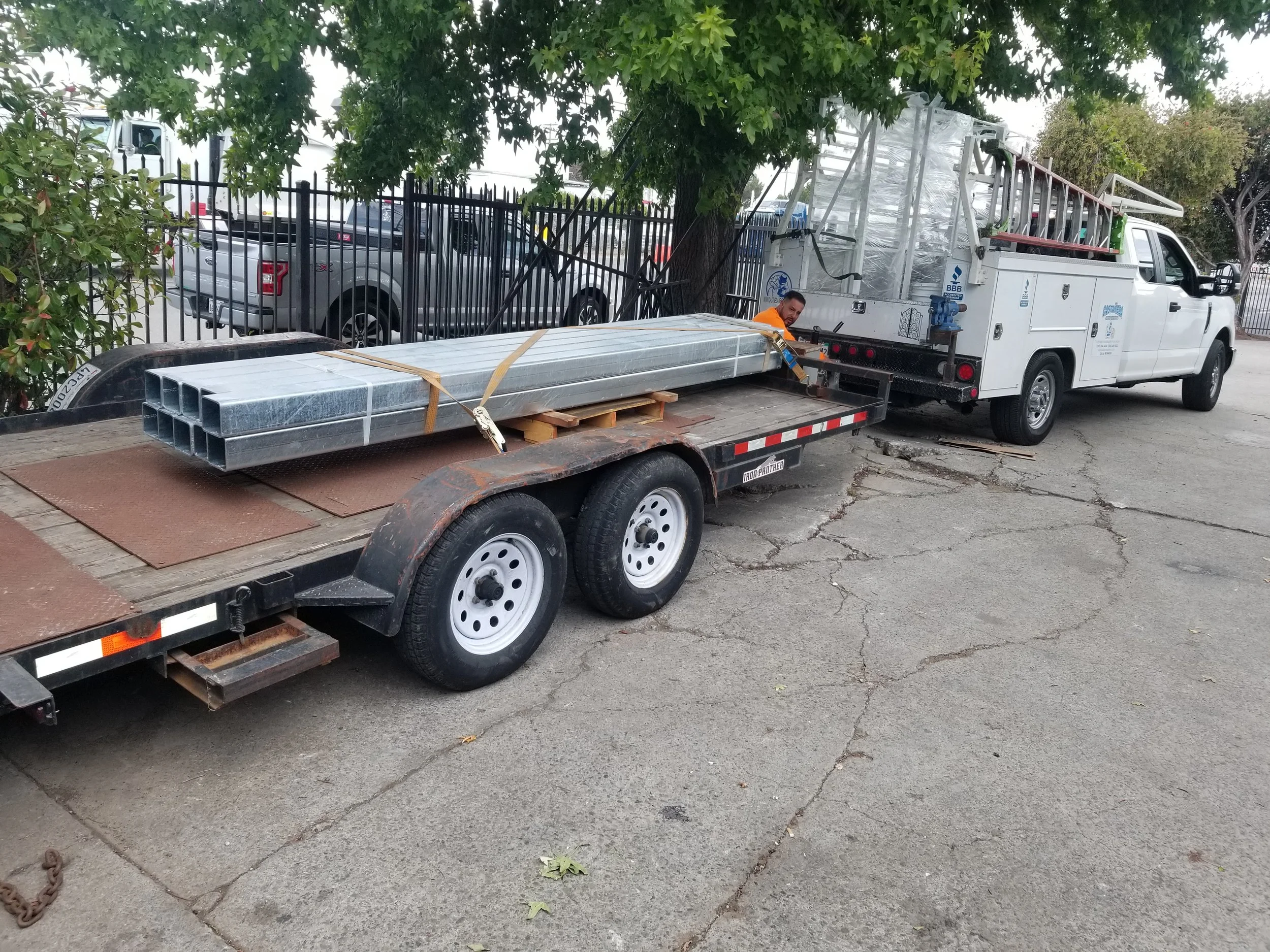 The white company car has on it the parts of an iron project. 