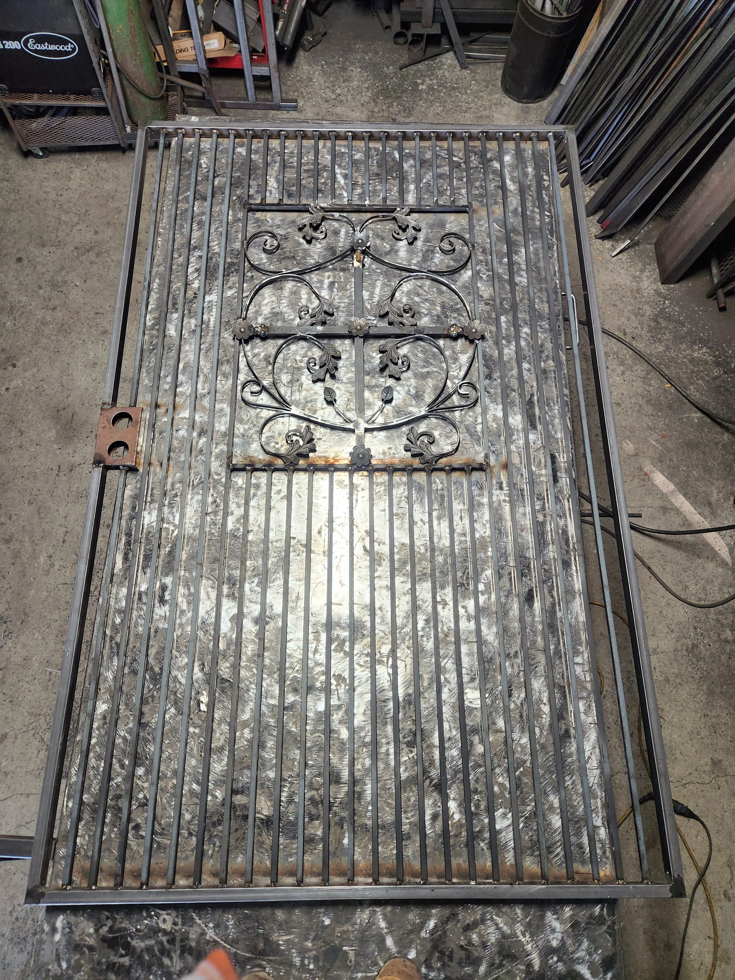 The iron company is in the process of working on the iron gate for better security. This one in the middle has details that make the door look much more elegant and sophisticated. 
