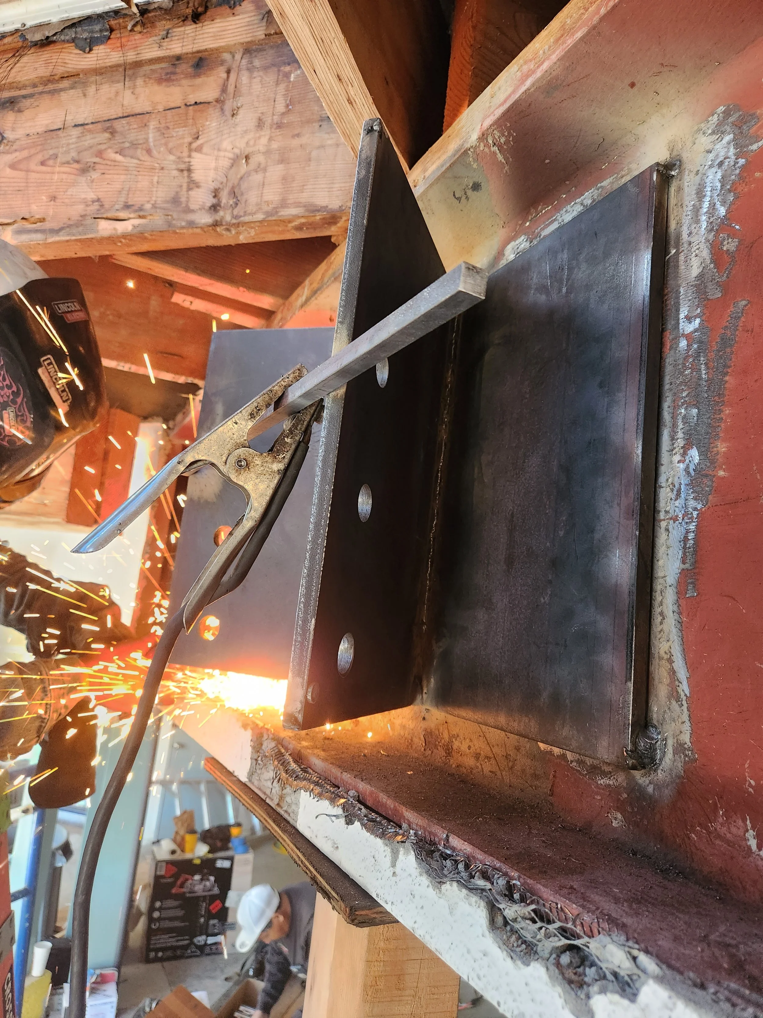 The expertise of an experienced ironworks professional at work. Donned in protective uniform, this skilled artisan is shaping excellence in a welding project. 