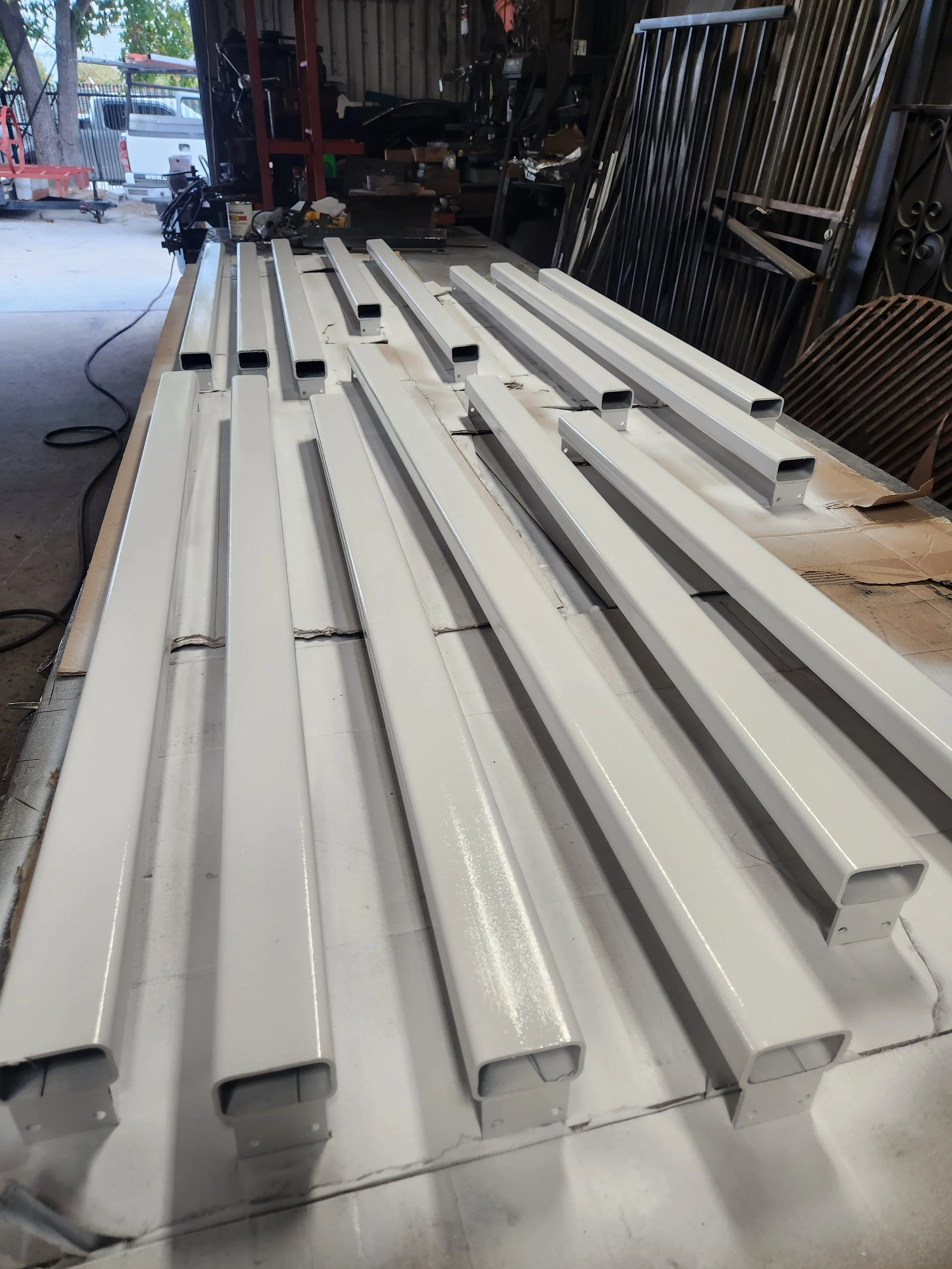 The elegance of our gallery featuring white-painted welding columns, meticulously crafted by our ironworks expert.