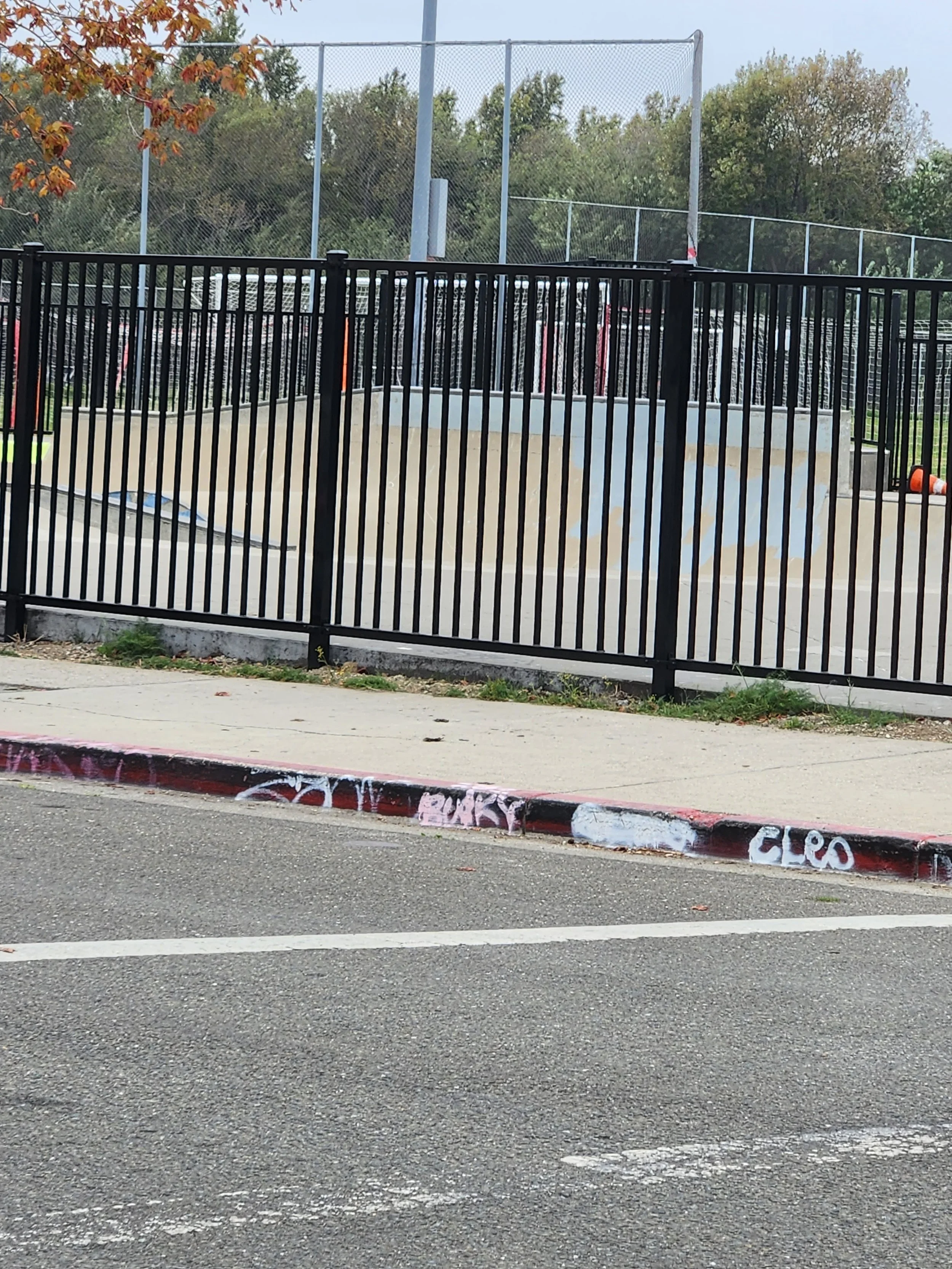 Black rectangular fence made of iron material and welded by the expert in the Bay Area in a children's playground.
