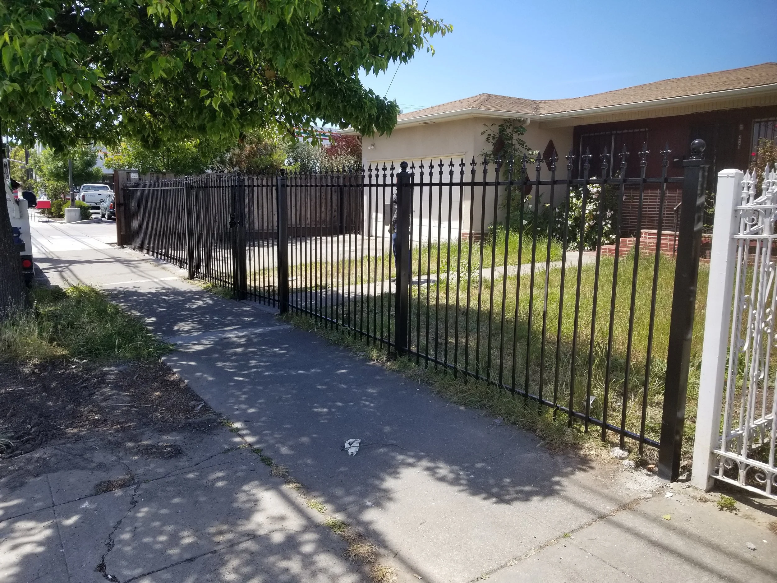 A security fence separating the main street with a house designed with iron and welded by the best professional in Northern California regions.