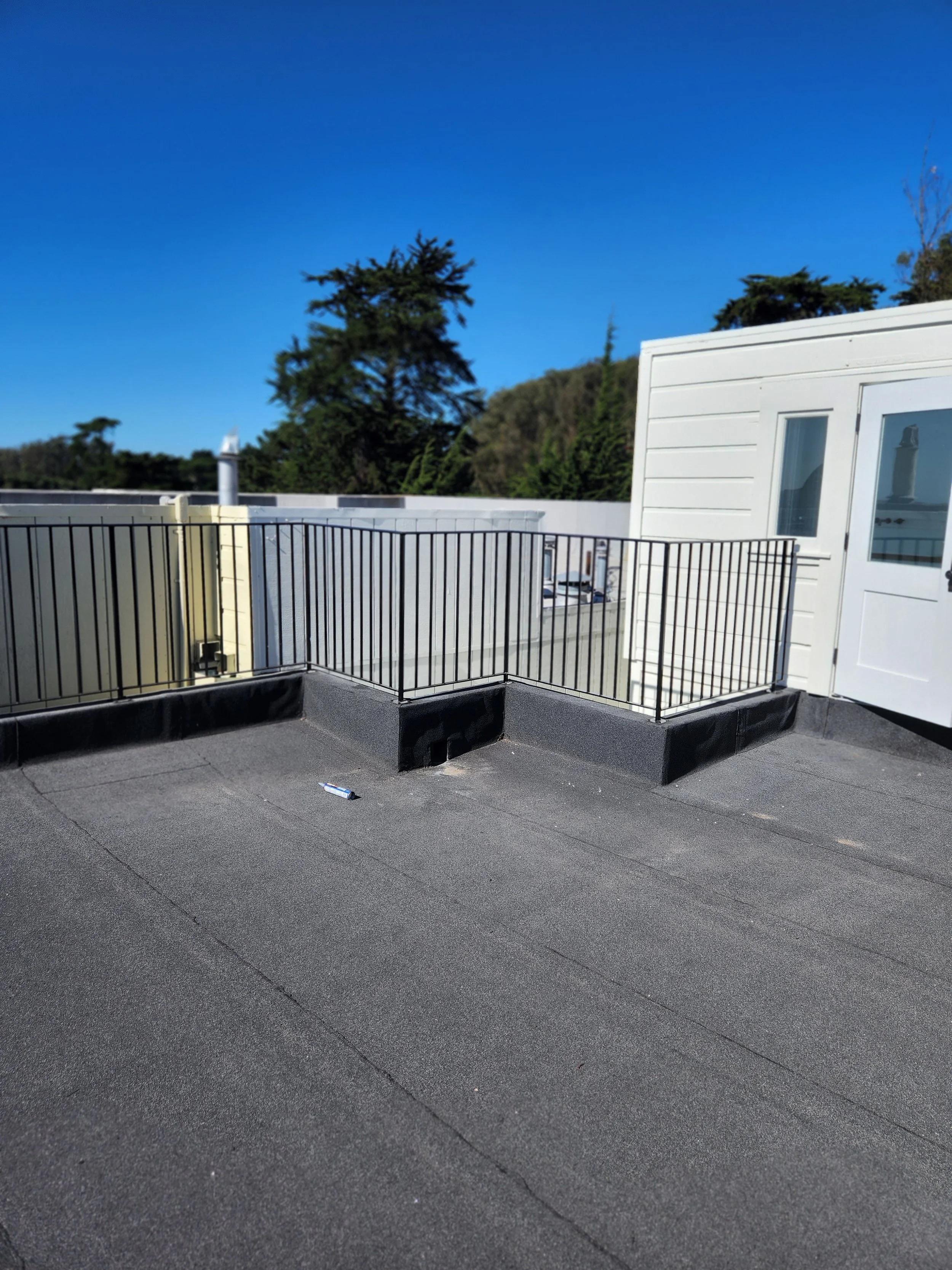 Guardrail for a house with white walls and blue windows