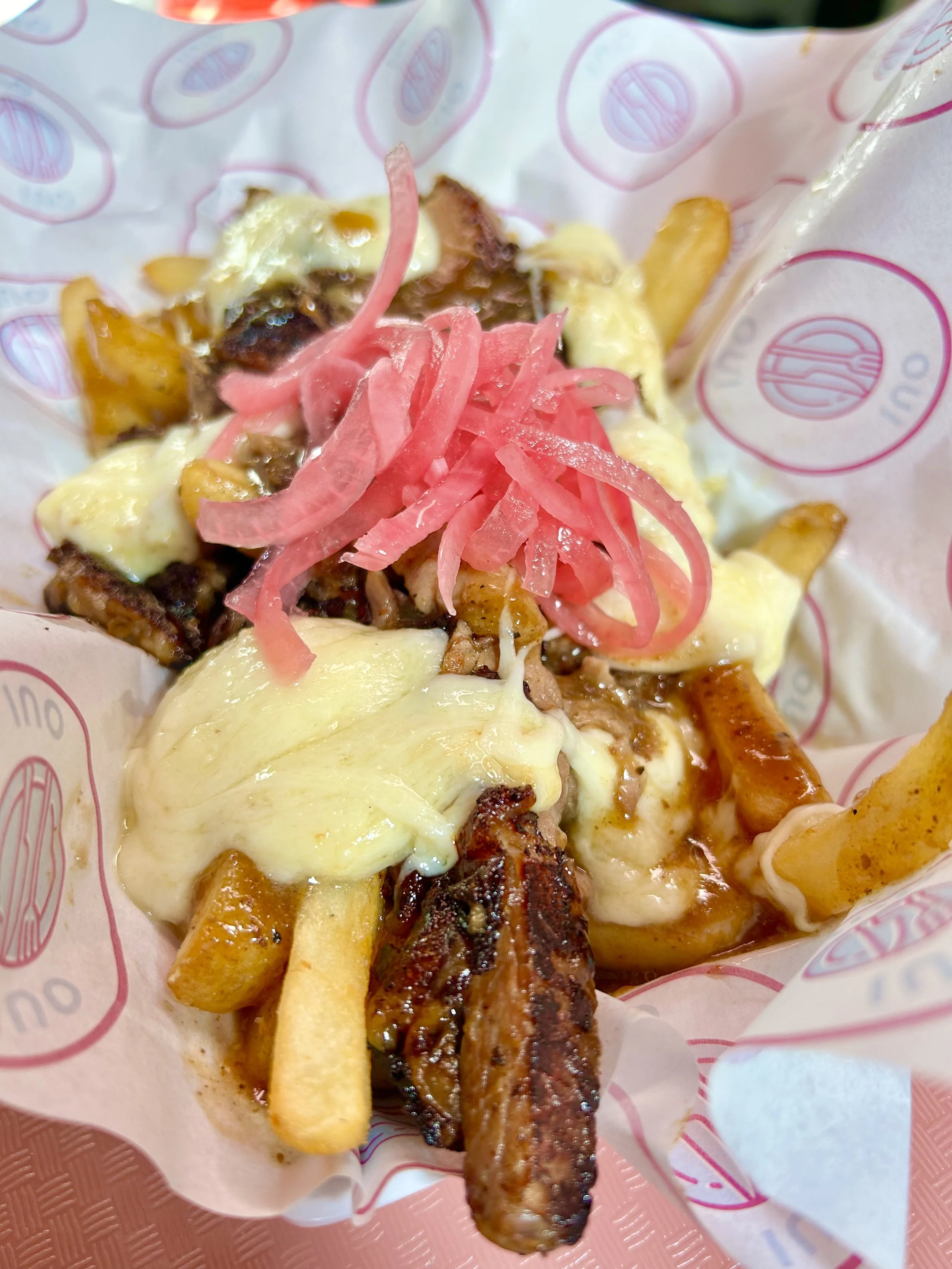 Loaded fries topped with melted cheese, grilled beef, and pickled pink onions.