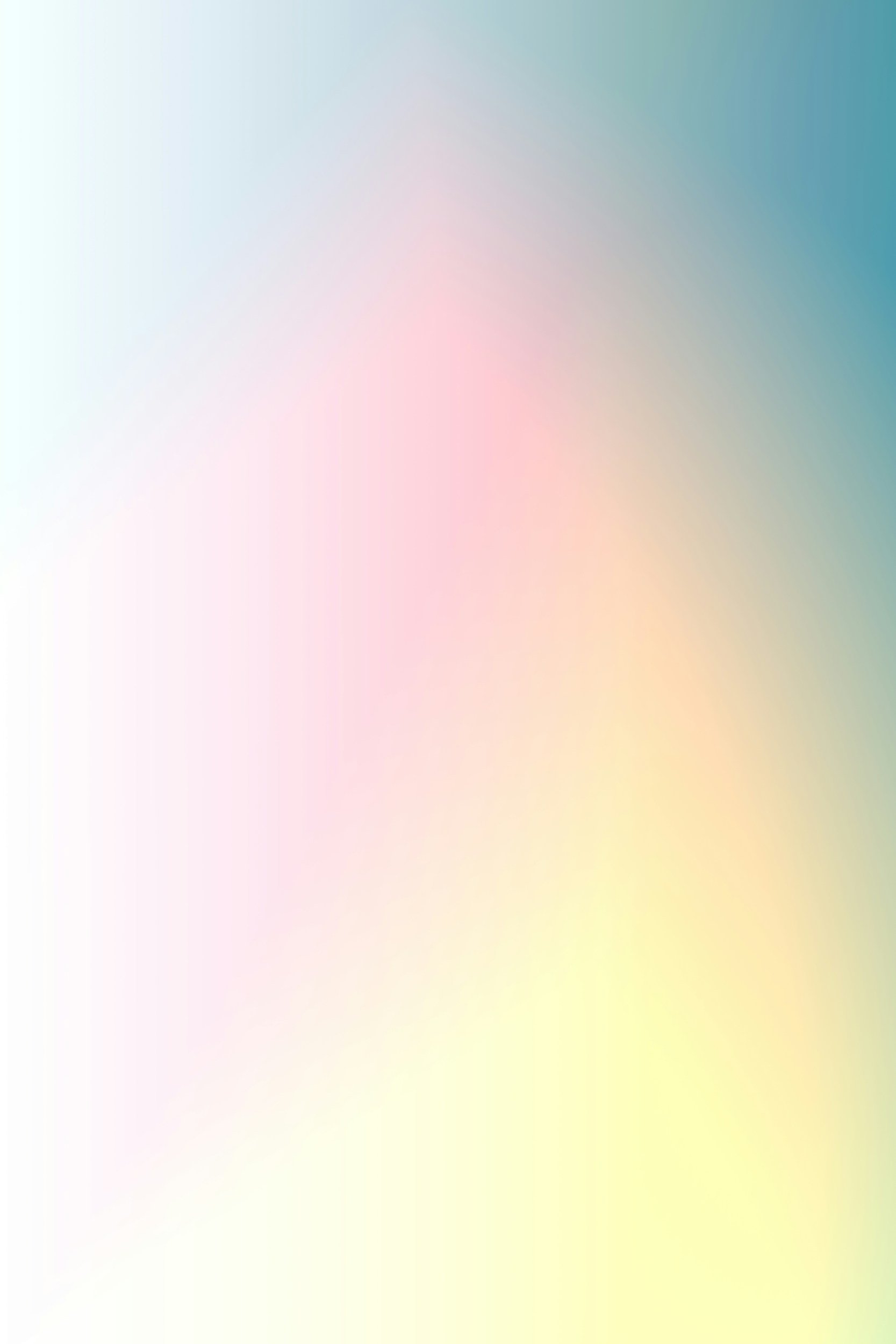 Blurred pastel-colored background with soft gradient shades of blue, pink, yellow, and green.