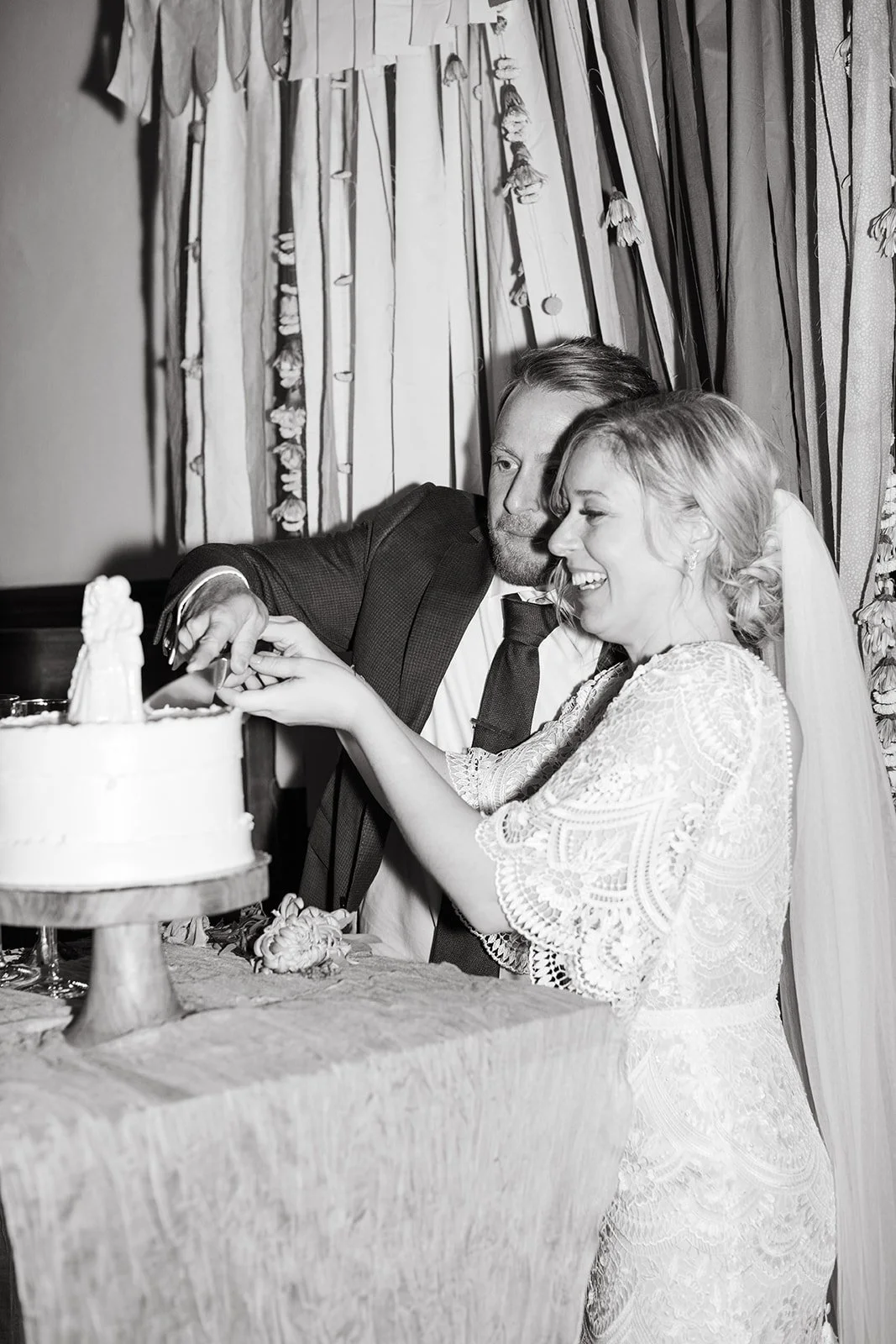 bride and groom cut vintage cake together at intimate DIY wedding