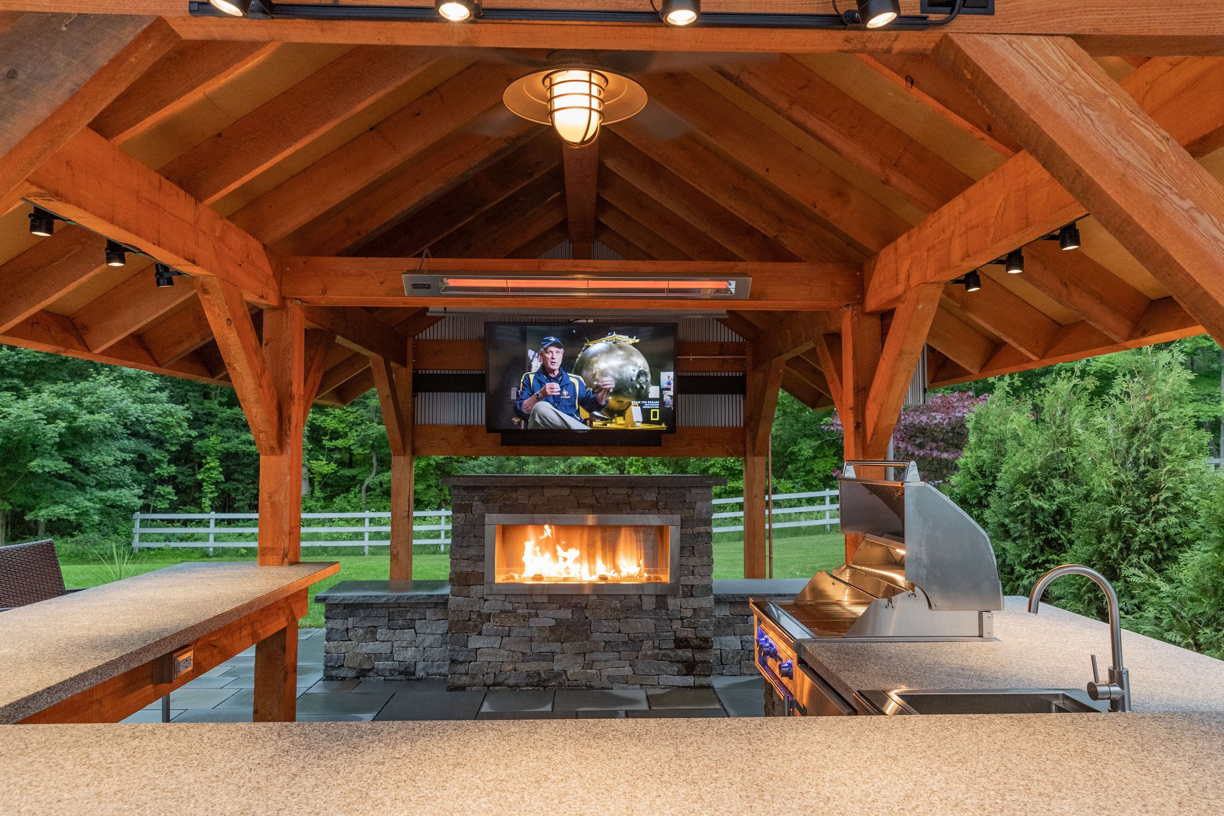 coverd fire place and TV by vermont landscape architect