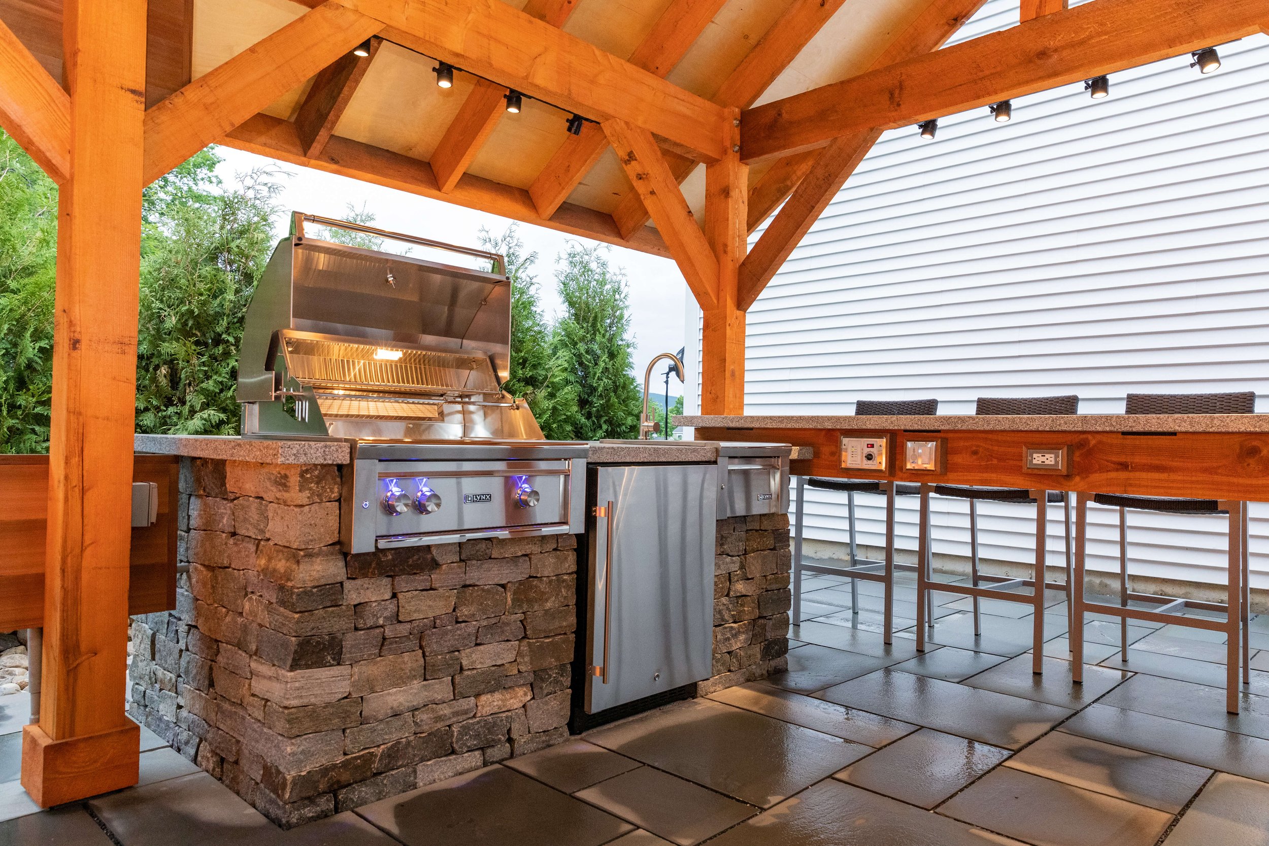 stainless steel grill and refrigerator designed by vermont landscape architect