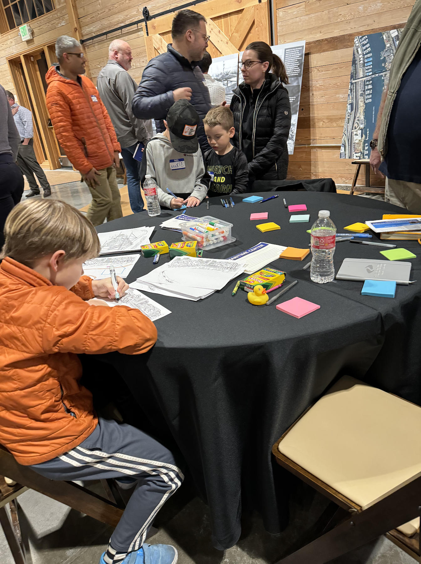 Kids are sitting at a table coloring