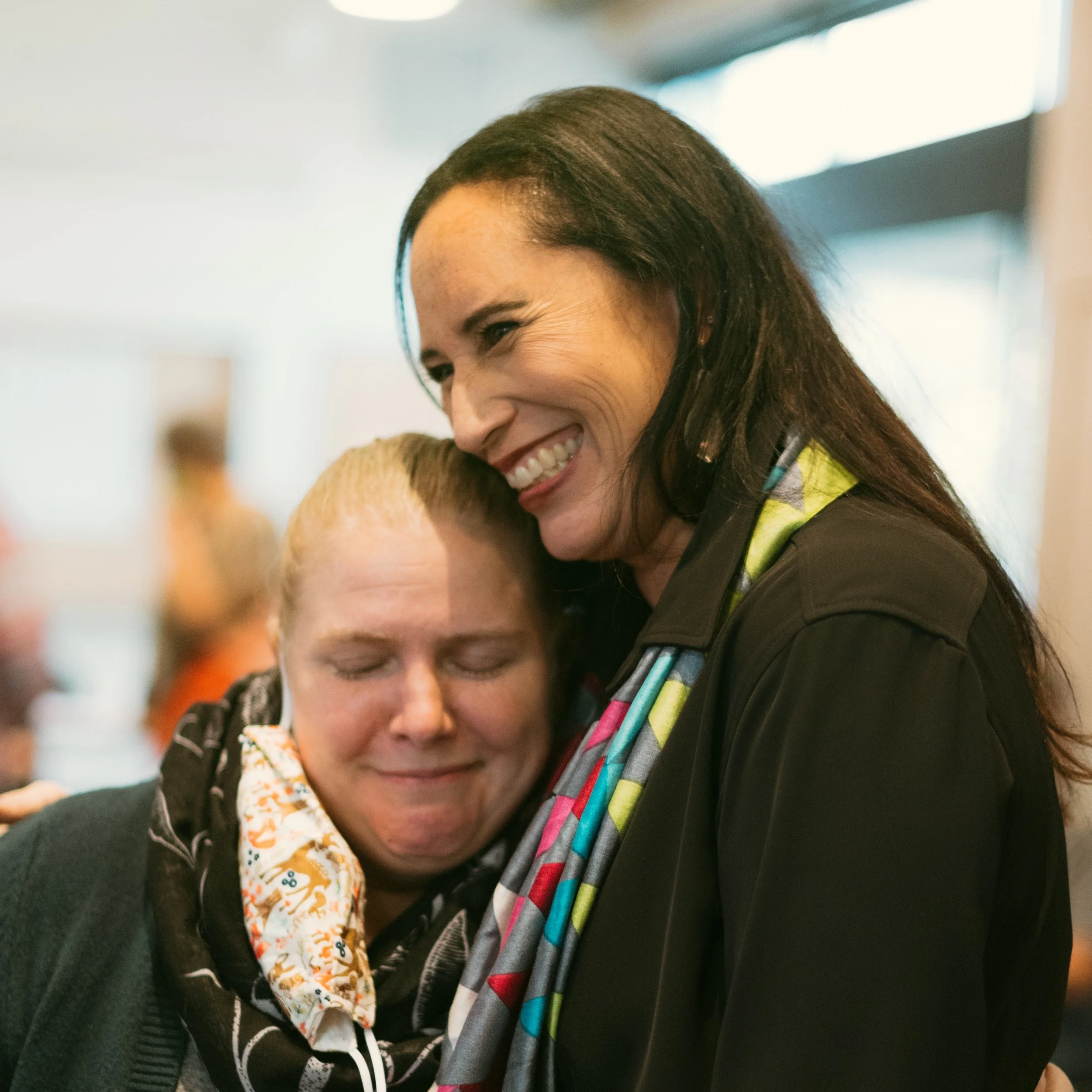 Two people smiling while embracing