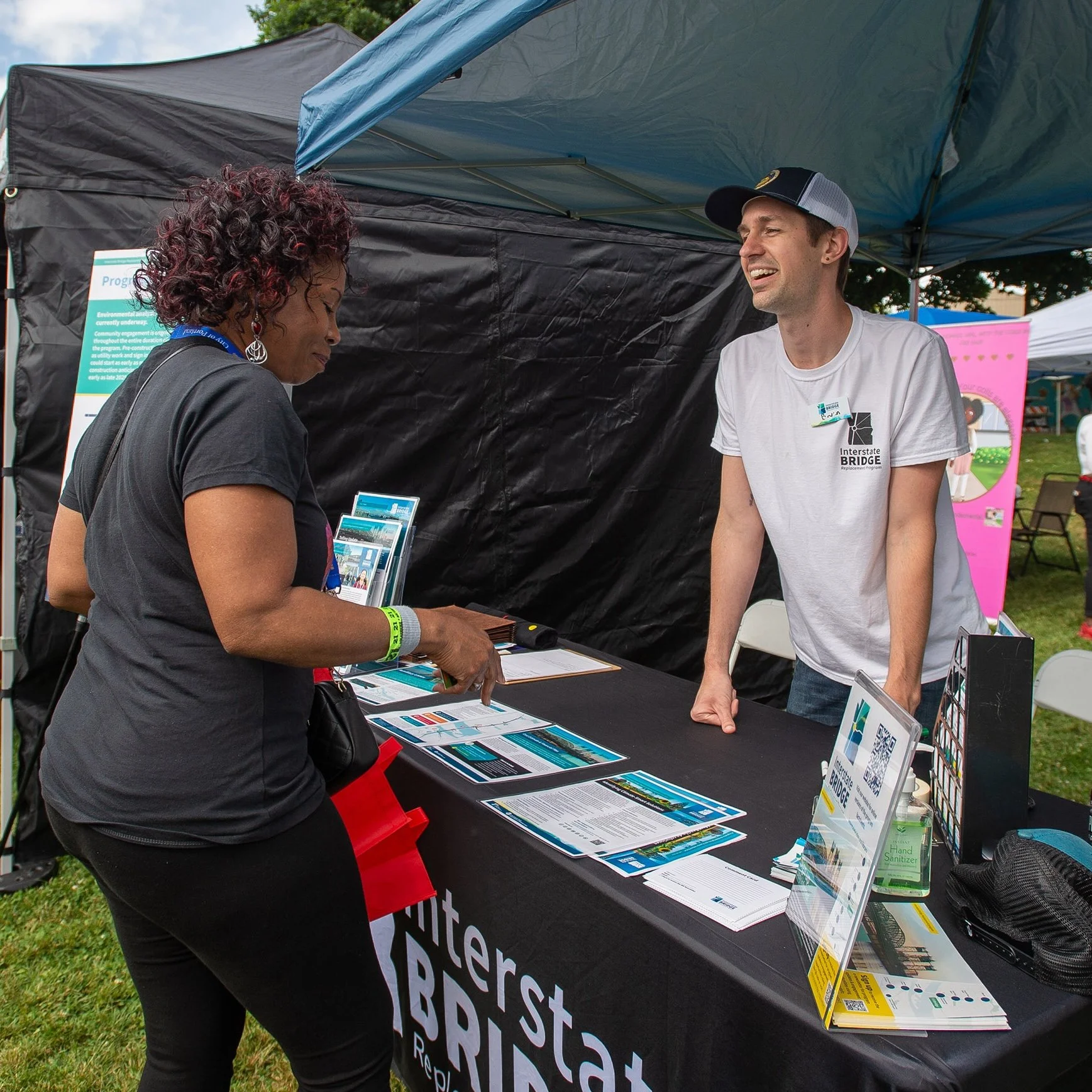Two people talking at a booth