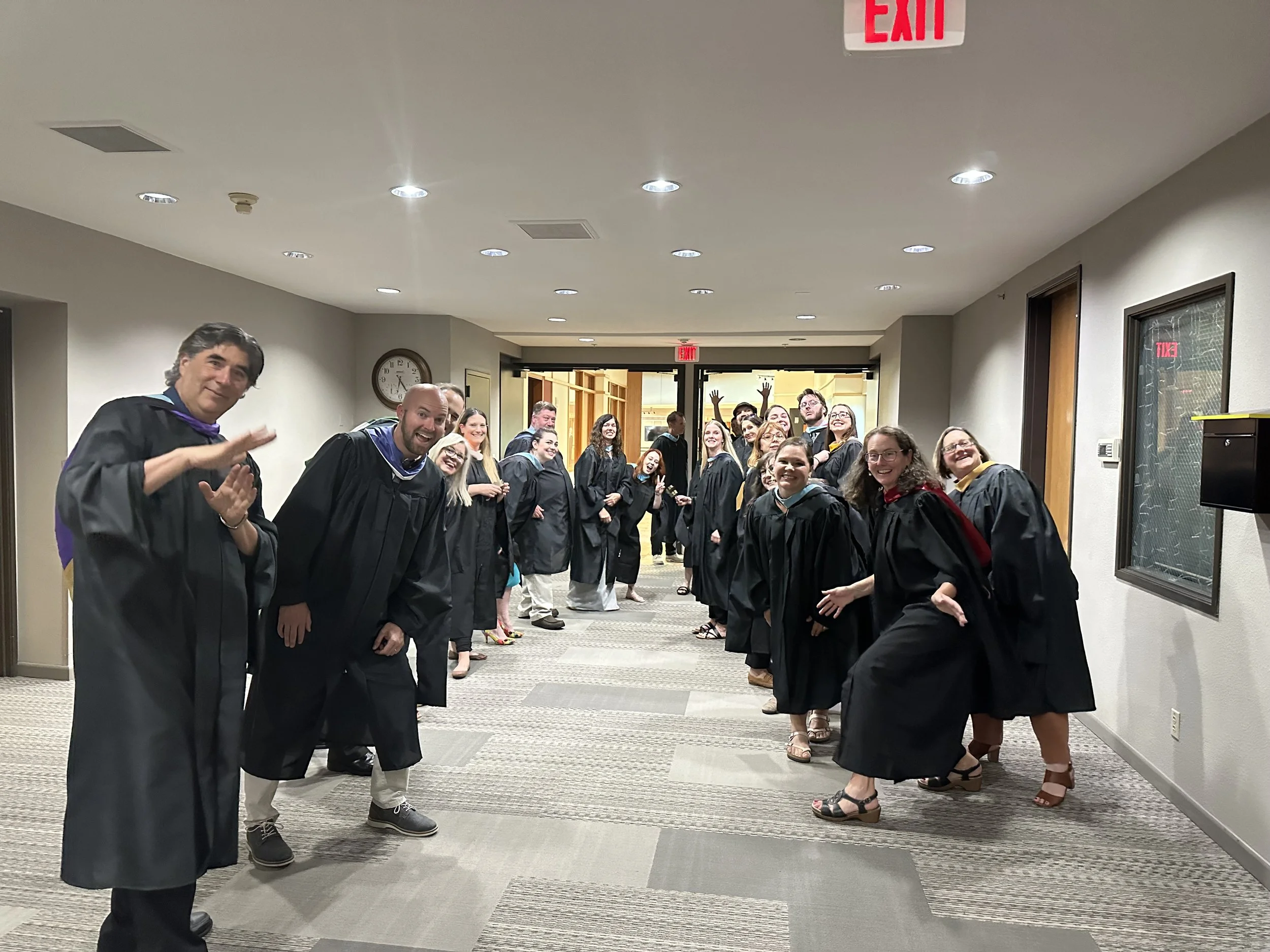 Large group of educators posing at graduation