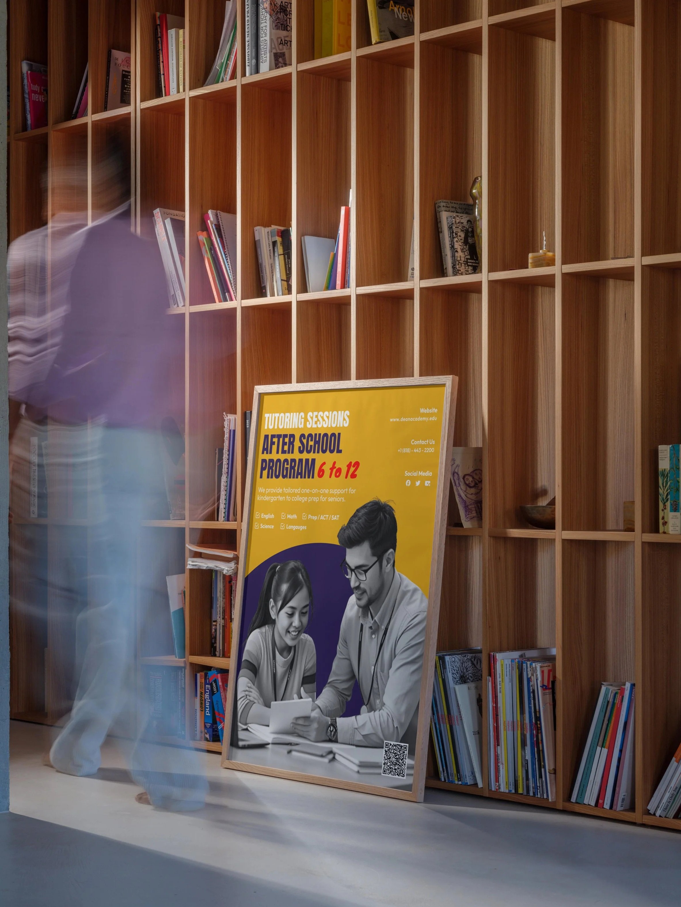 A mockup of a tutor program poster that is inside of a wooded frame in front book shelfs.