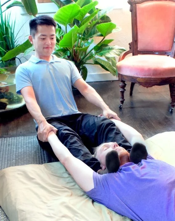 Arms are stretched while shoulders are compressed with the feet.